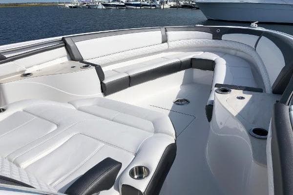 Luxurious seating area on a 2020 Fountain 43 NX boat, featuring sleek white upholstery.