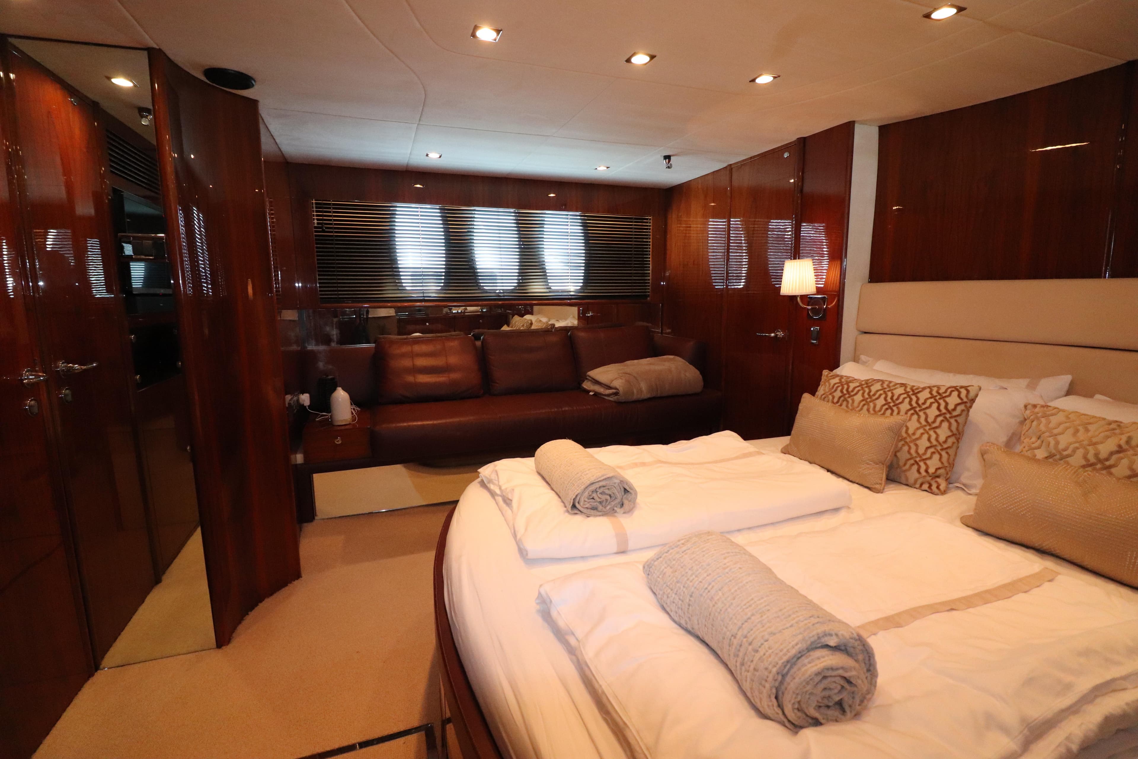 Luxurious bedroom interior of 2007 Fairline Squadron 68 yacht with elegant wood finishes.