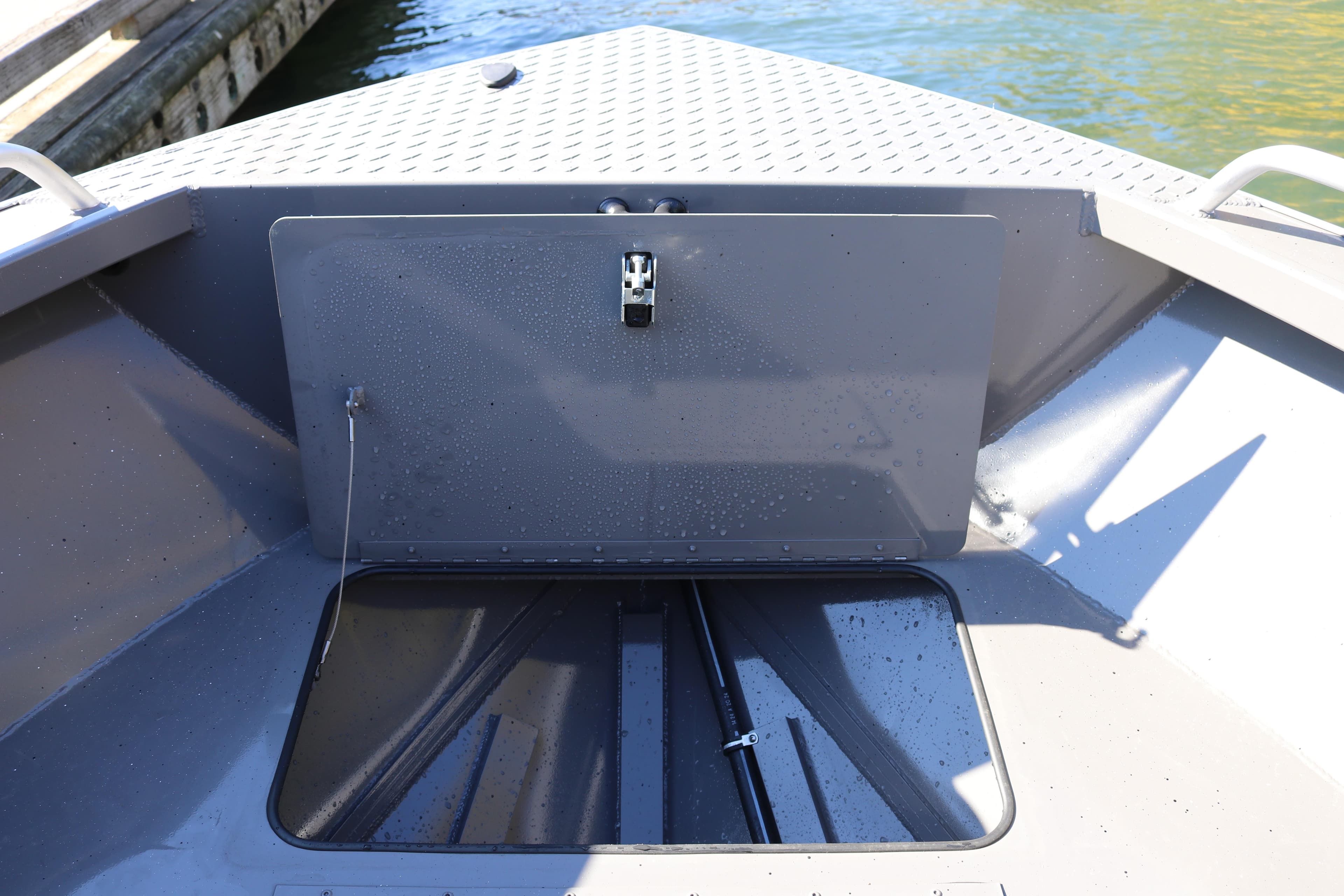 2026 Alumaweld Stryker 220 boat storage compartment, open hatch, dockside view.