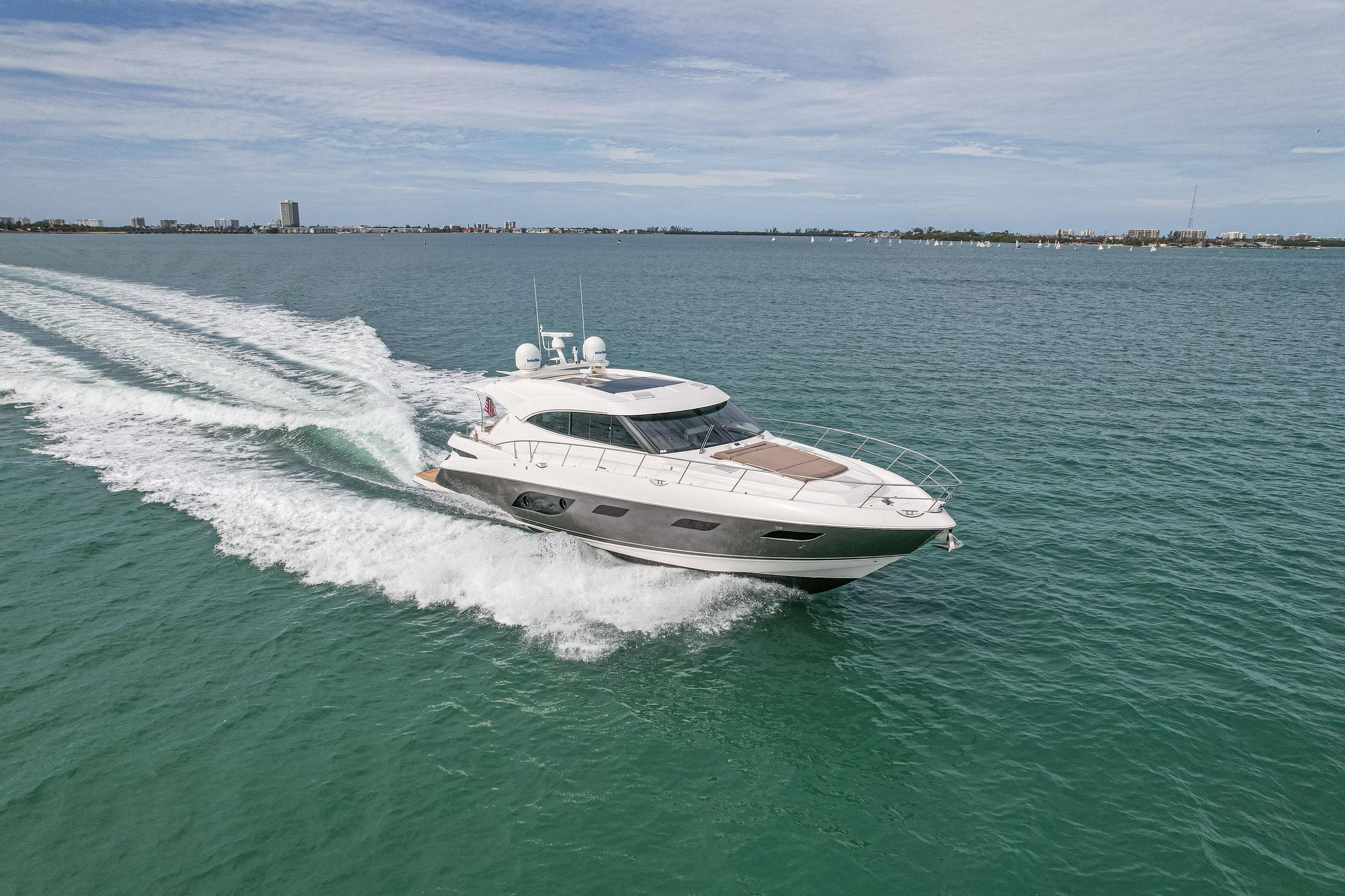 2015 Riviera 6000 Sport Yacht cruising on open water under a clear sky.