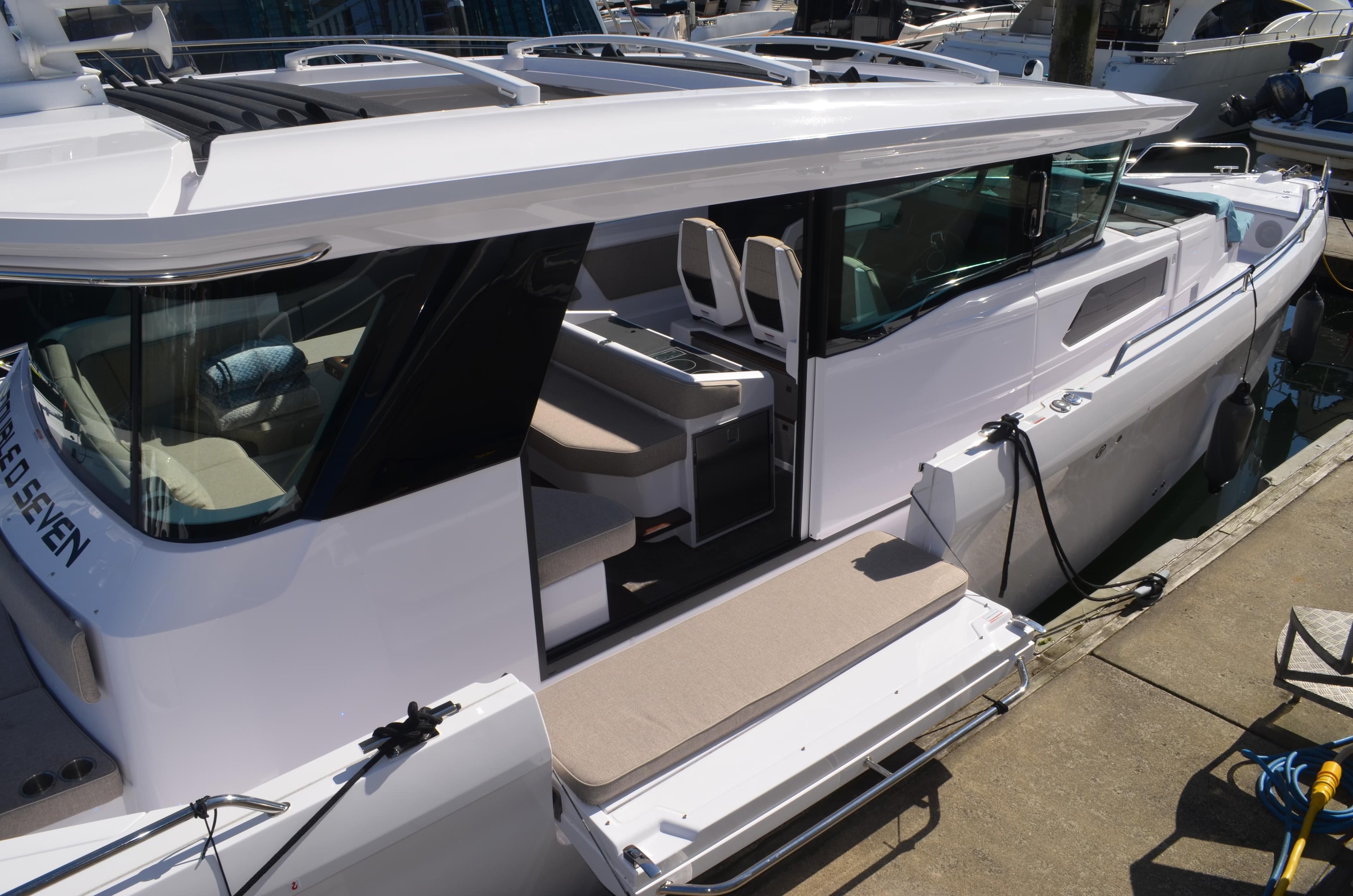 2023 Axopar 45 XC Cross Cabin boat docked, showcasing sleek design and spacious interior.