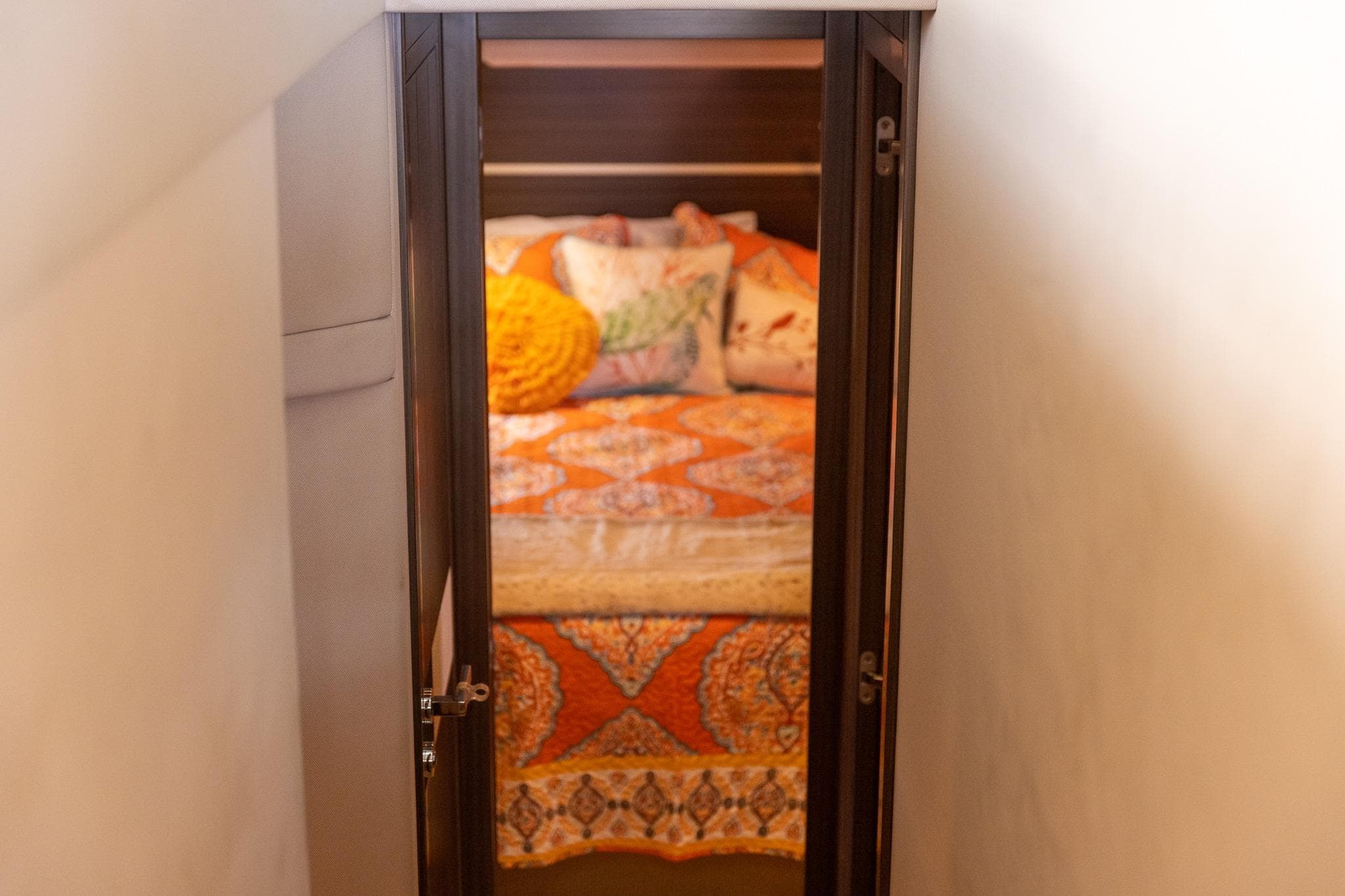 Cozy bedroom with vibrant bedding inside 2014 Azimut 54 Flybridge yacht.