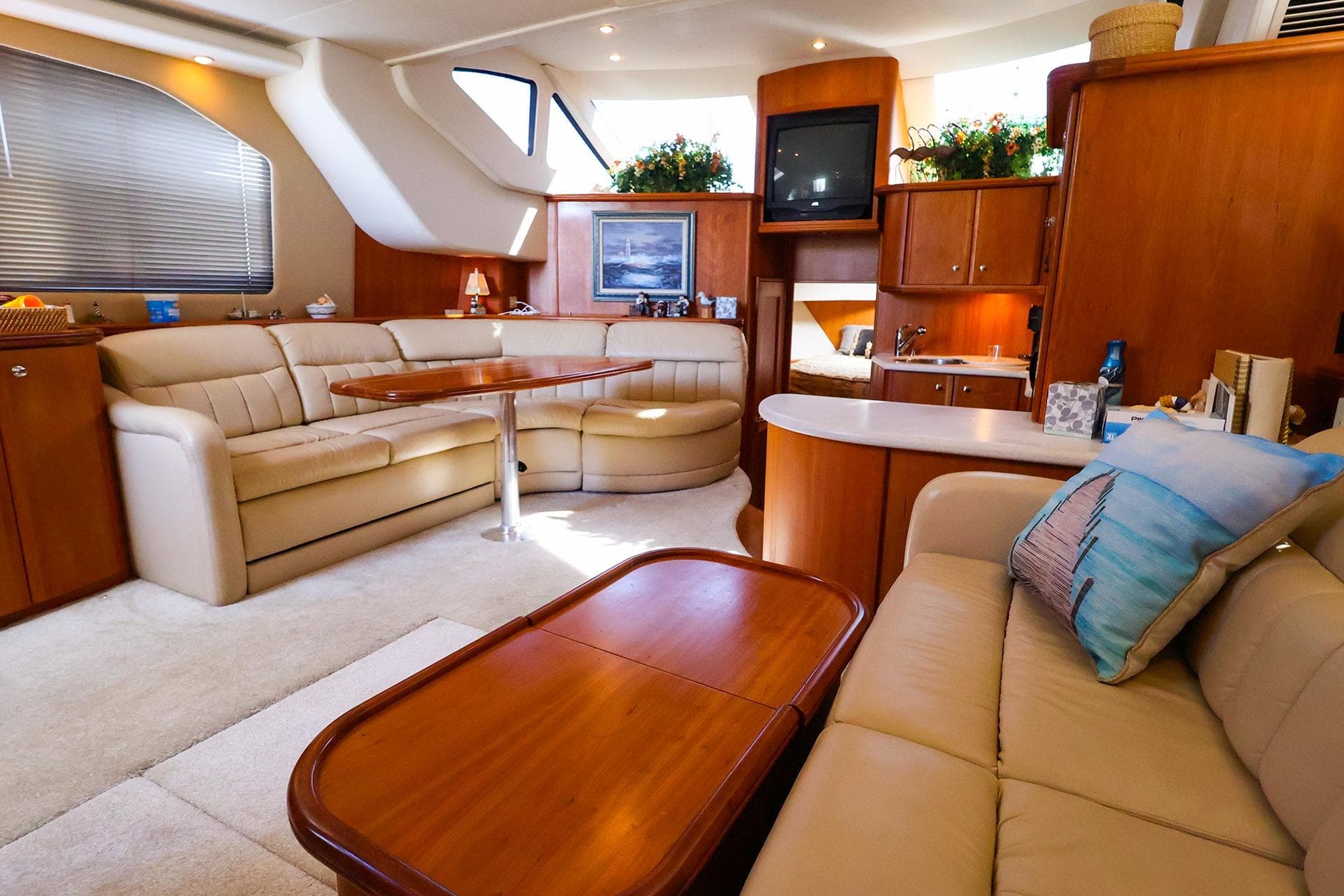Luxurious interior of 2002 Silverton 43 Motor Yacht with elegant seating and wooden accents.
