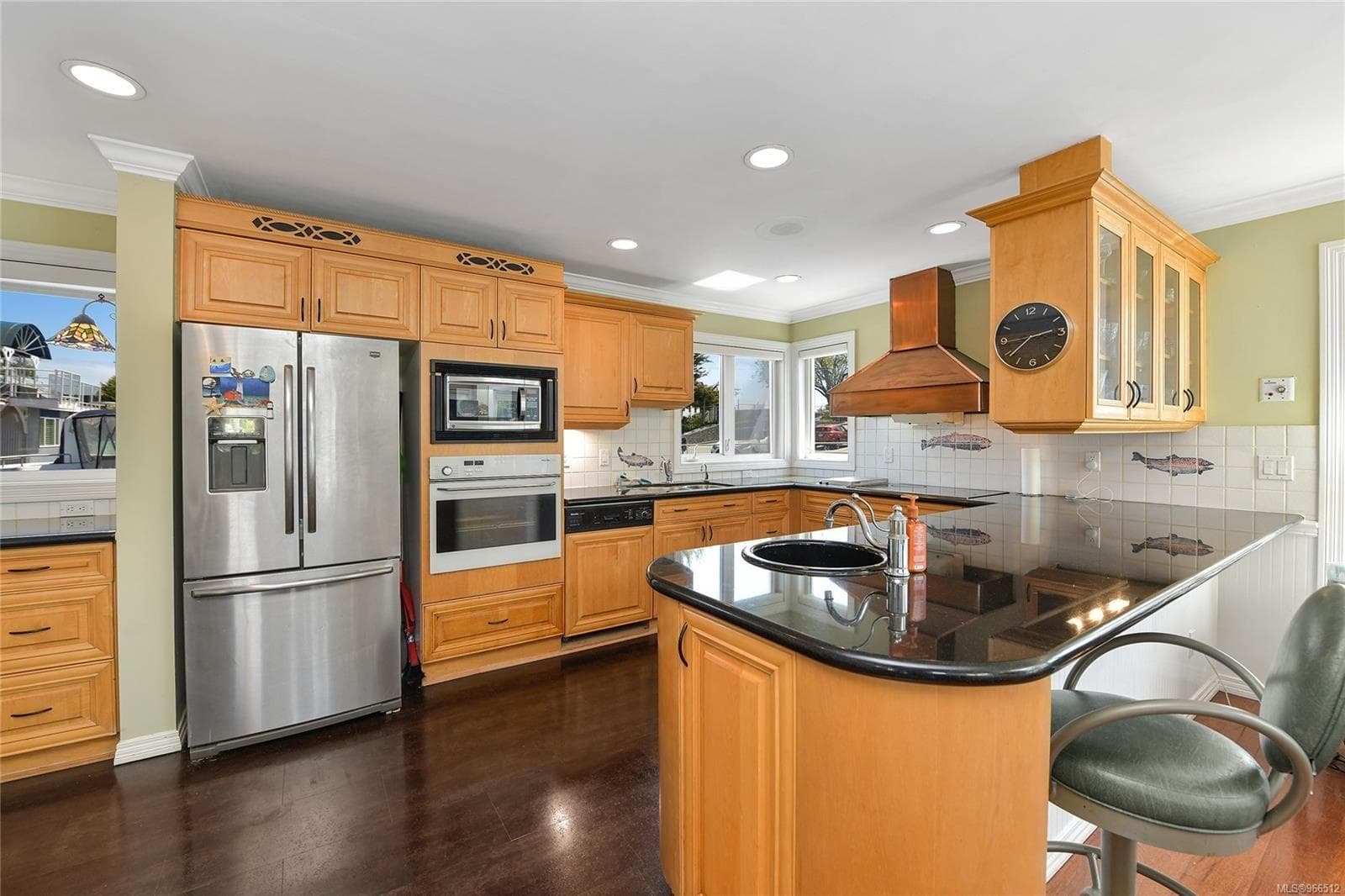 Spacious kitchen in custom 2005 float home with wooden cabinets and modern appliances.