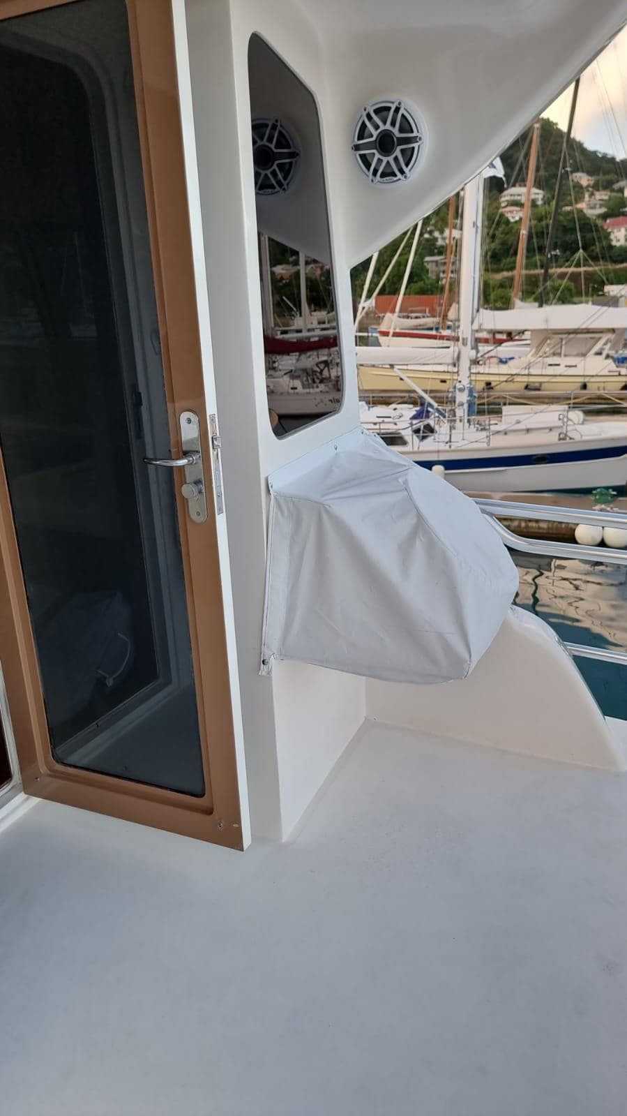 2009 Bertram 700 Enclosed yacht deck with door and covered equipment.