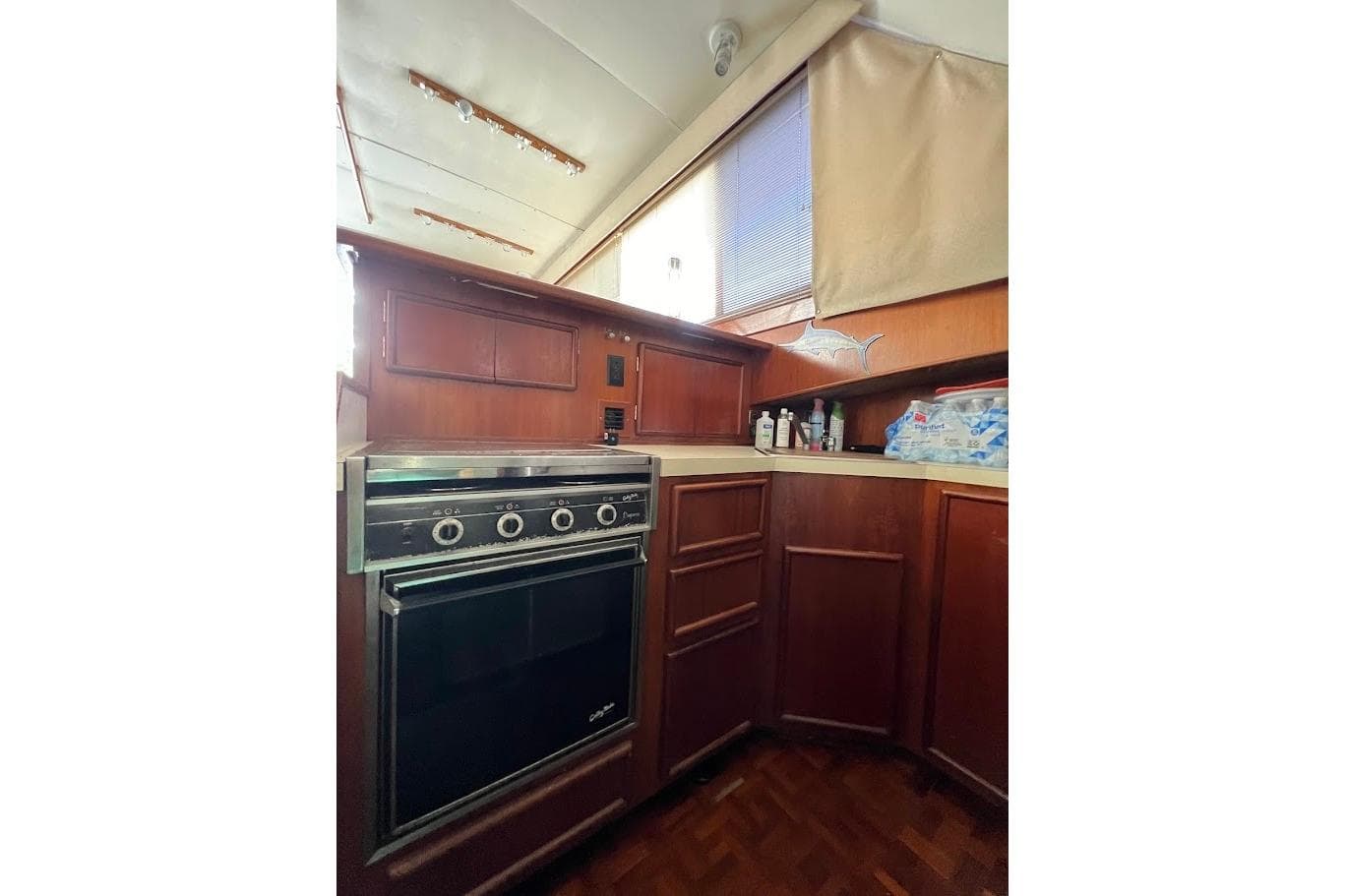 1988 Post 46 ll yacht kitchen with wood cabinets and built-in oven.