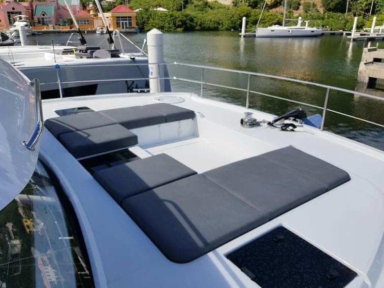 2021 Fountaine Pajot MY6 yacht with spacious deck and seating area in marina.