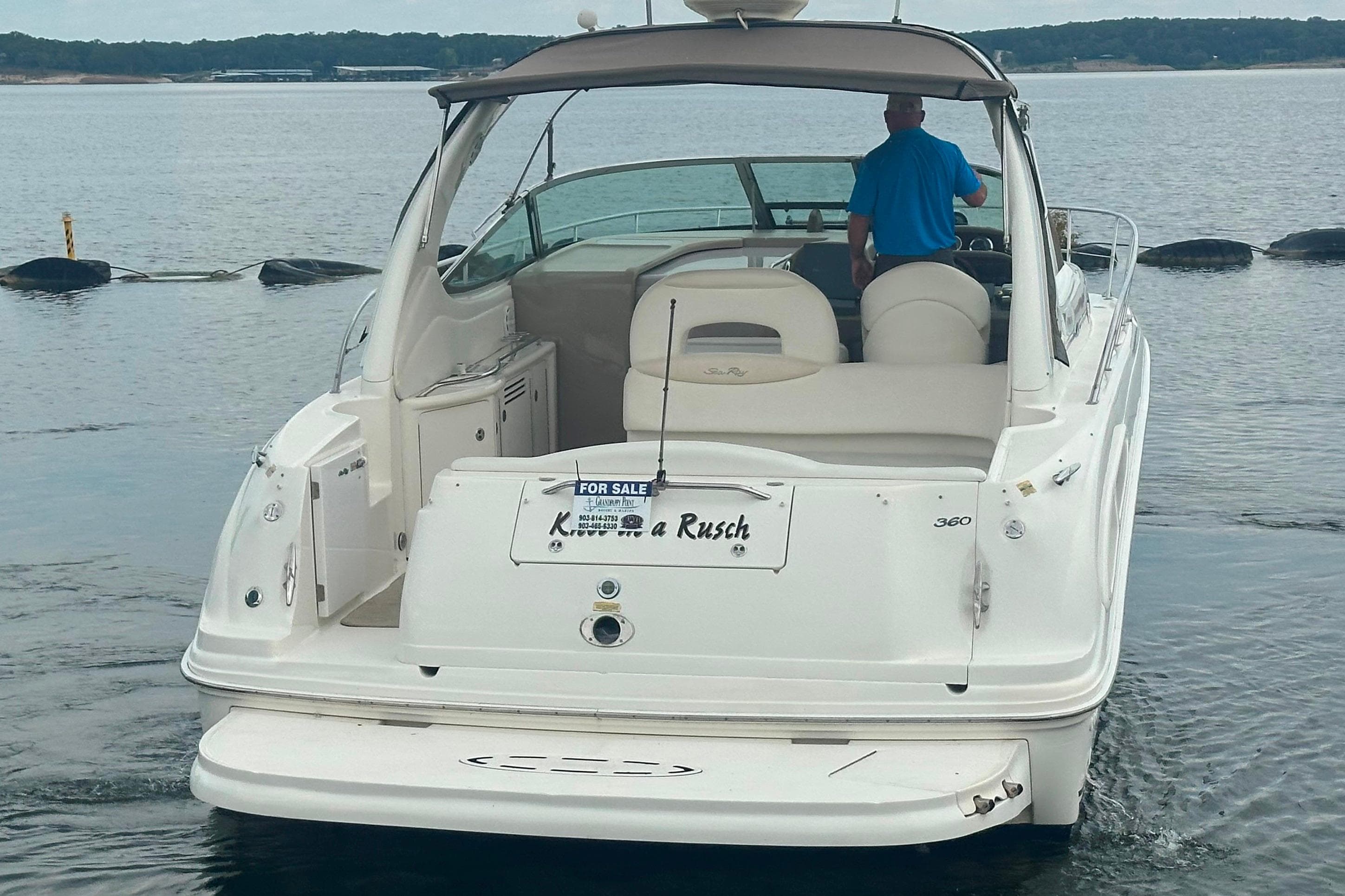 2002 Sea Ray 360 Sundancer boat on water, rear view, with "For Sale" sign.