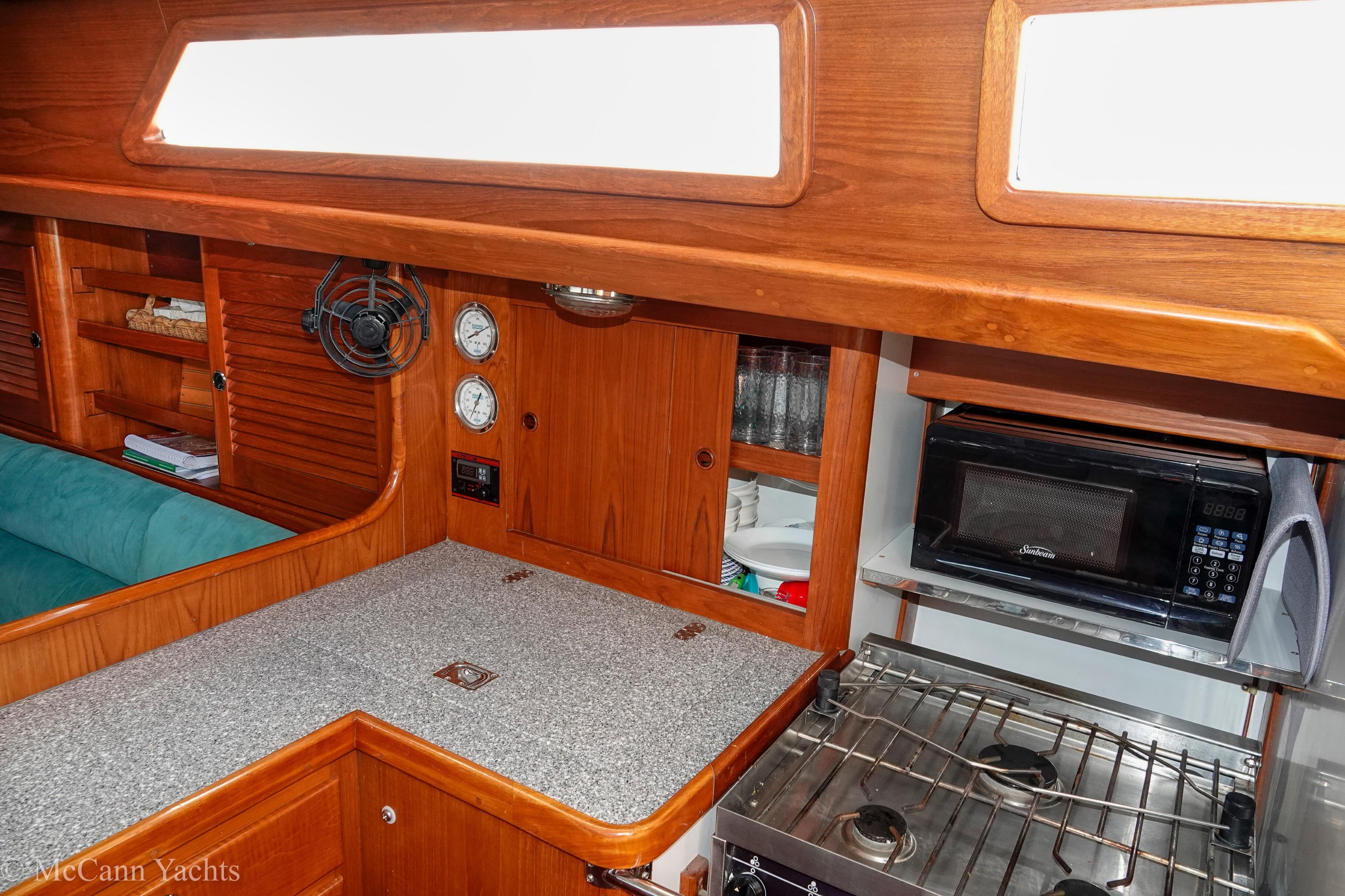 Cozy galley in 1993 Alden 43 Aft Cockpit yacht with stove and microwave.