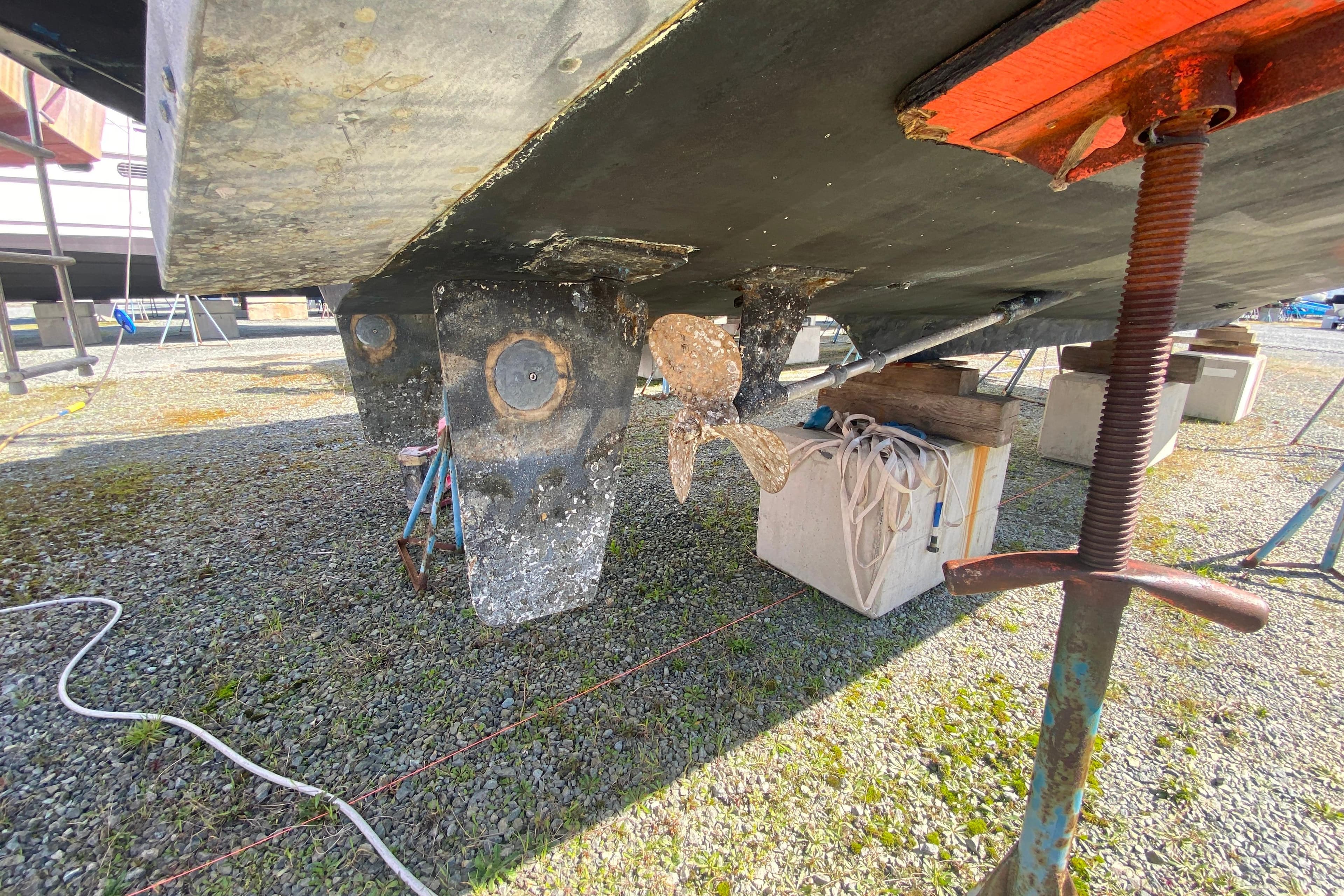 1984 Tollycraft 34 Convertible Sedan boat hull and propeller on dry dock.