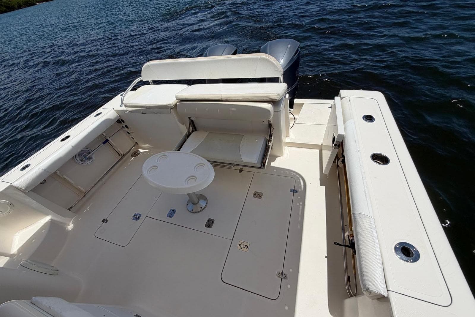 2010 Pursuit OS 345 Offshore boat deck with seating and table on the water.