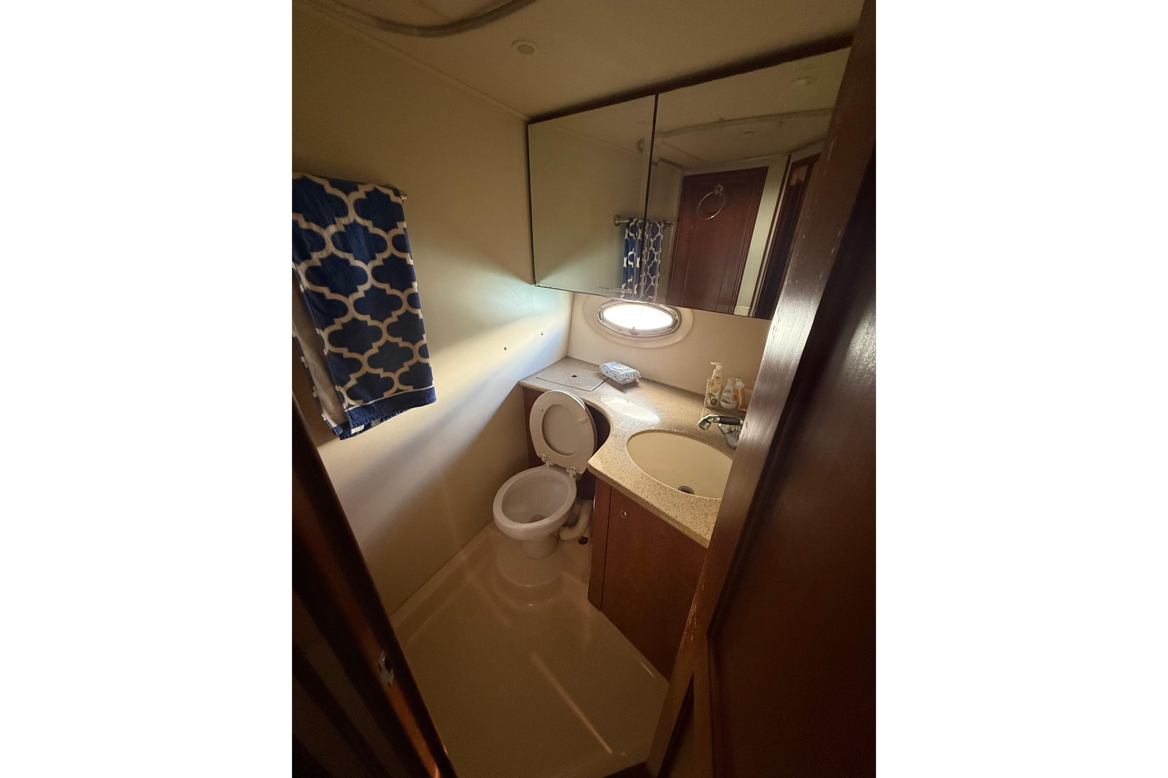 Bathroom interior of 2006 Silverton 36 Convertible yacht with sink and toilet.