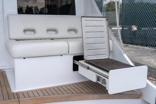 1997 Garlington Convertible yacht with built-in grill and cushioned seating.