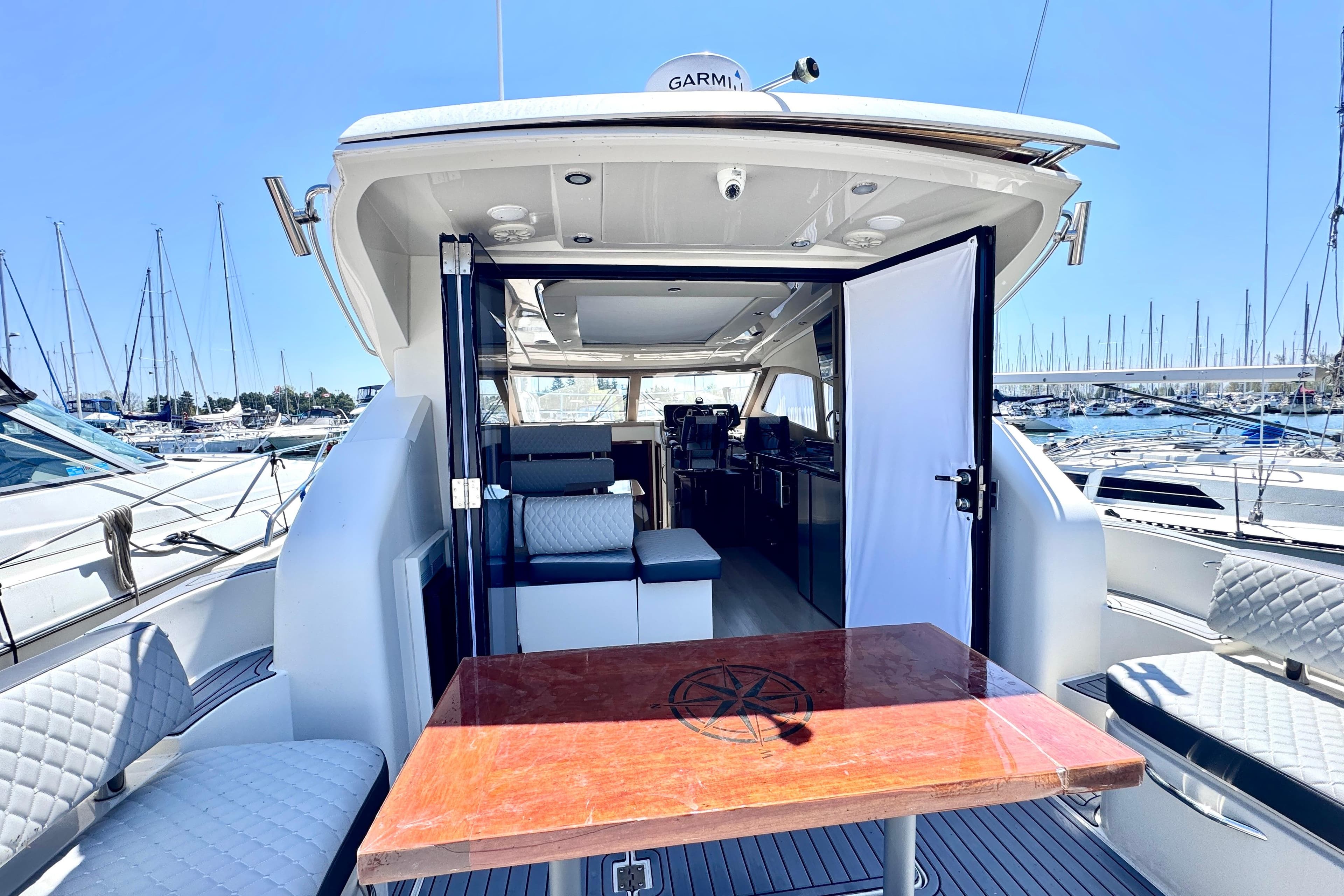 Luxury 2015 Carver C37 yacht interior with open deck and marina view.