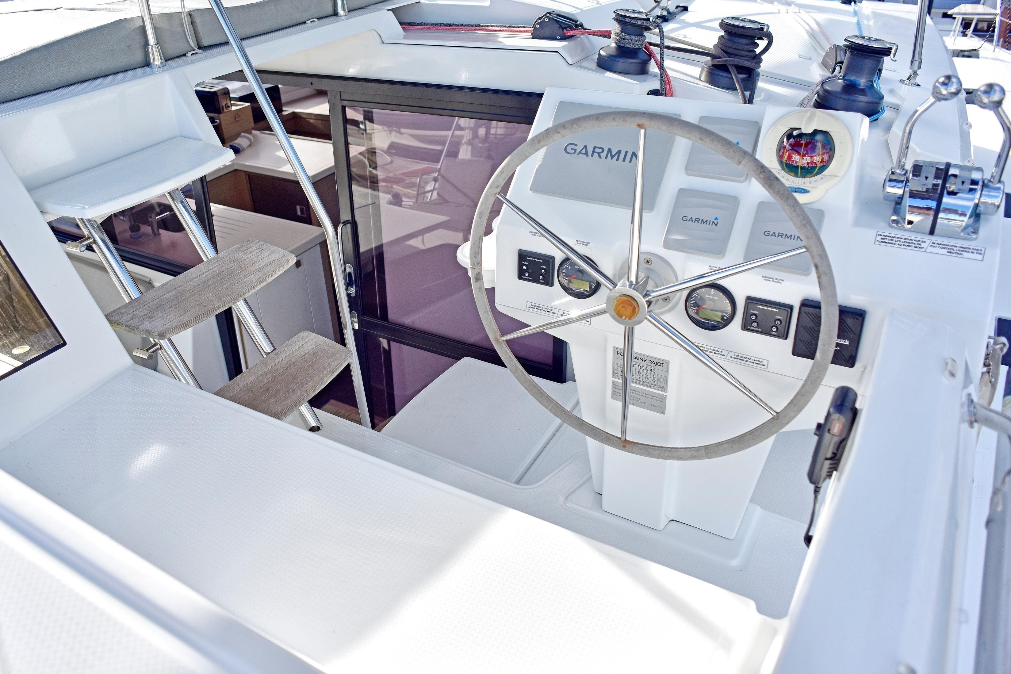 Cockpit of 2022 Fountaine Pajot Astrea 42 with Garmin navigation system and steering wheel.