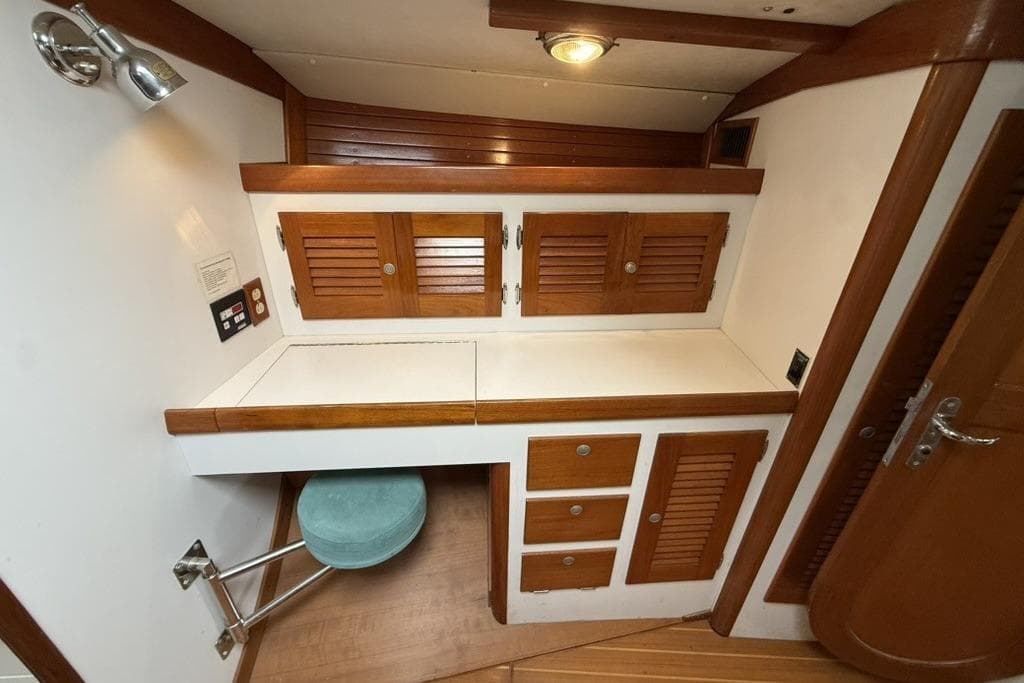 Interior of 1996 J Boats J/160 yacht with wooden cabinets and seating area.