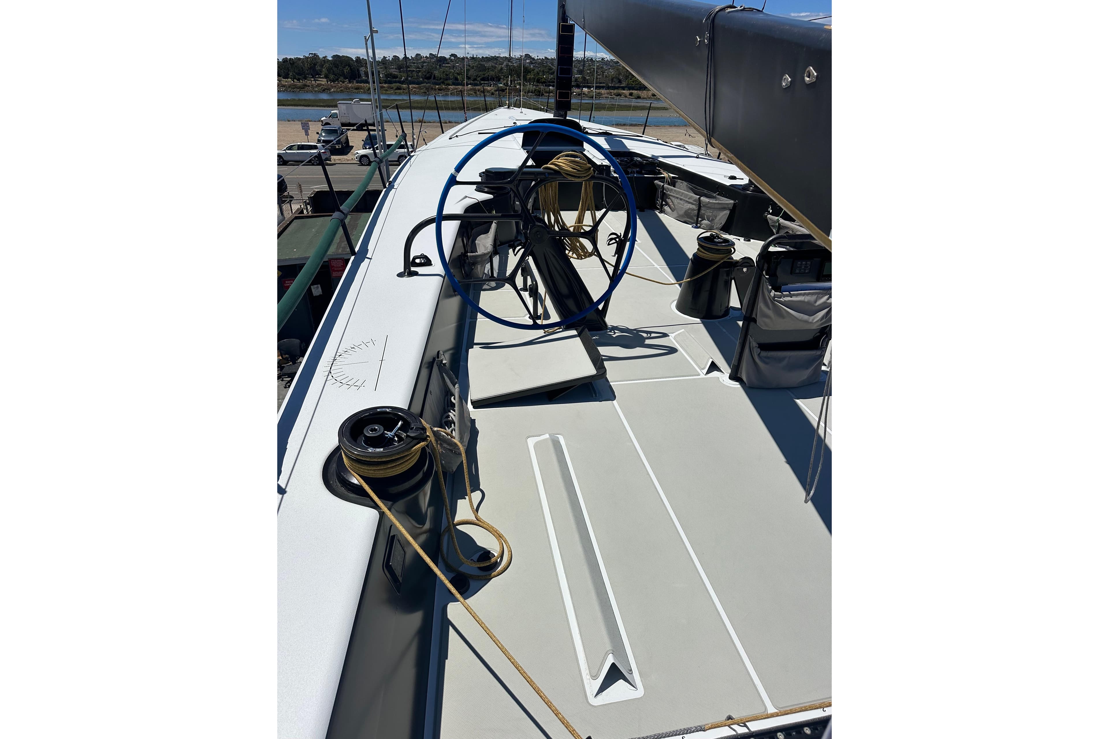 Sailing yacht deck of 2018 Botin 56, featuring winches and ropes under clear skies.