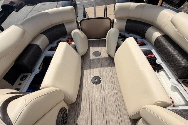 Luxurious interior of 2021 Premier 250 Grand Majestic RF pontoon boat with beige seating.