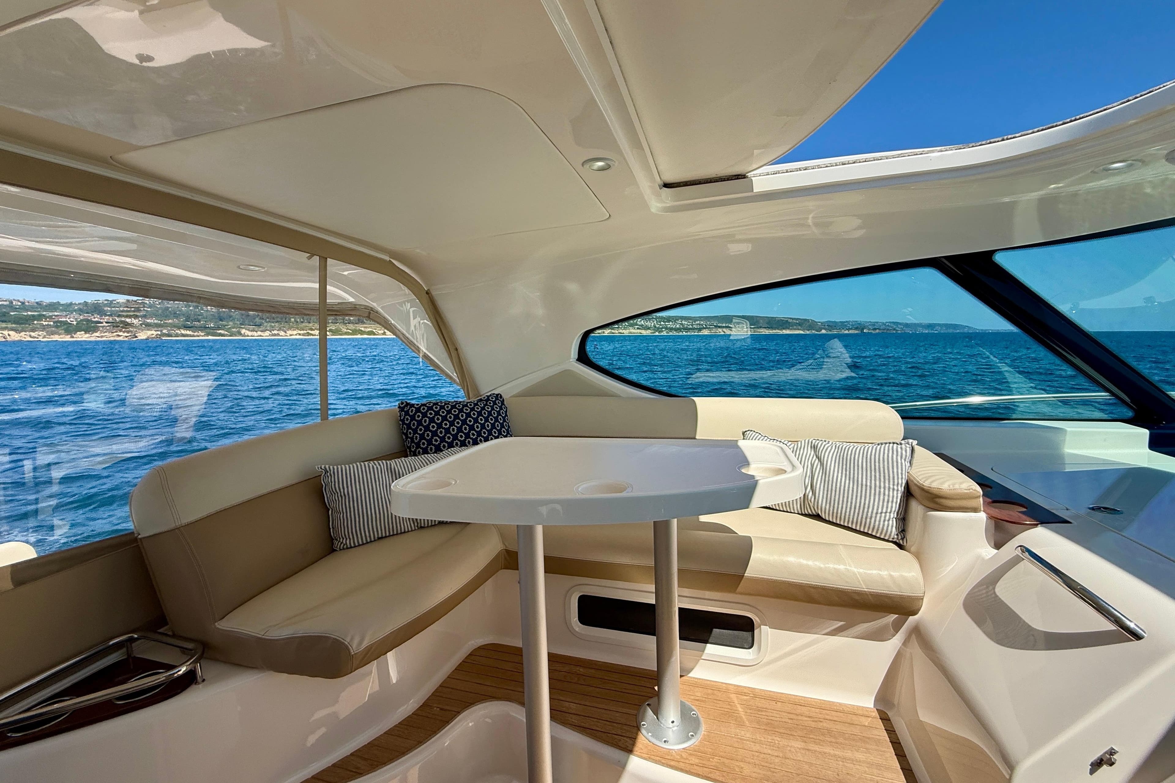 Luxurious interior of 2012 Tiara Yachts 4500 Sovran with ocean view and plush seating.