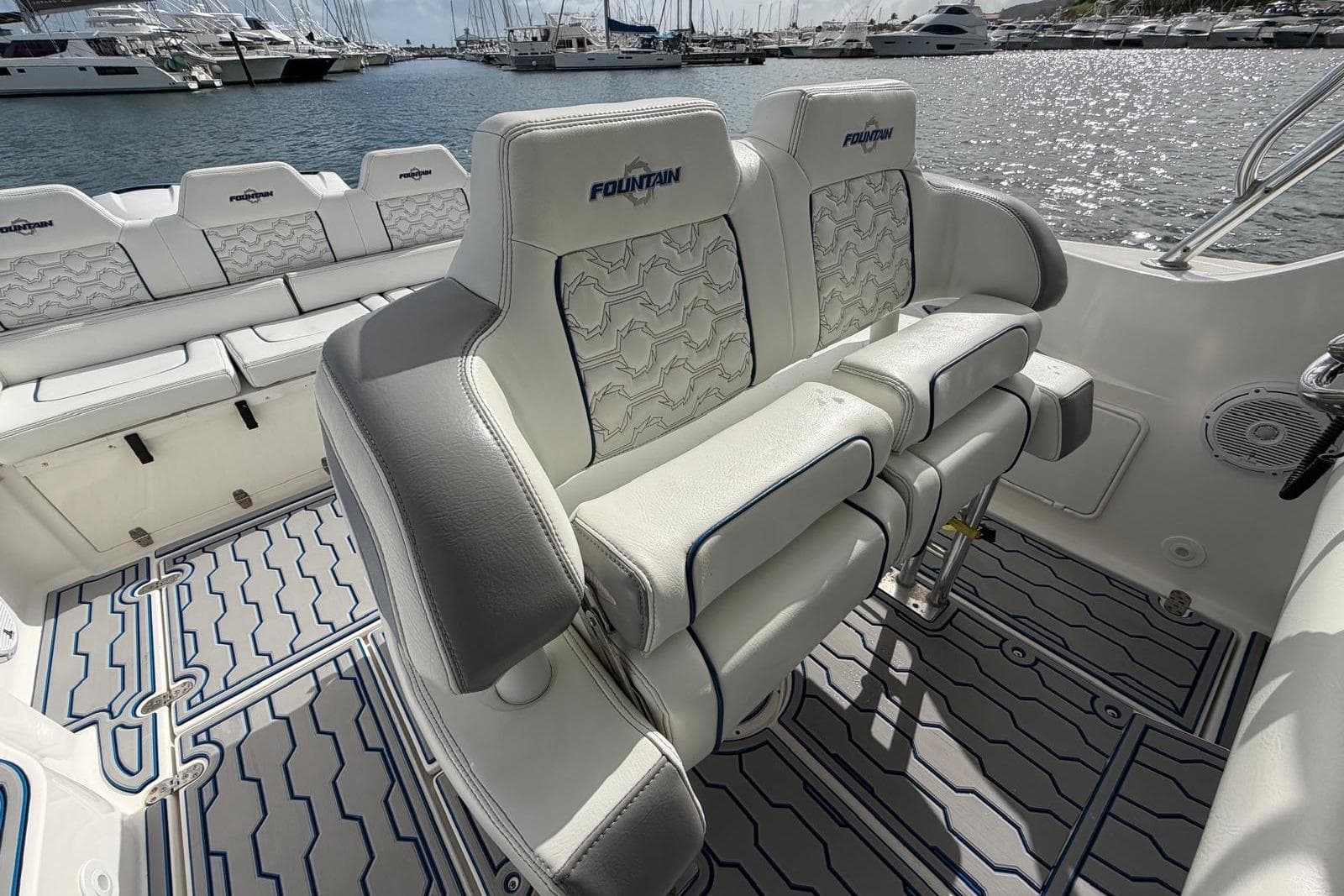 2007 Fountain 38 Tournament Edition boat interior with cushioned seating and marina view.