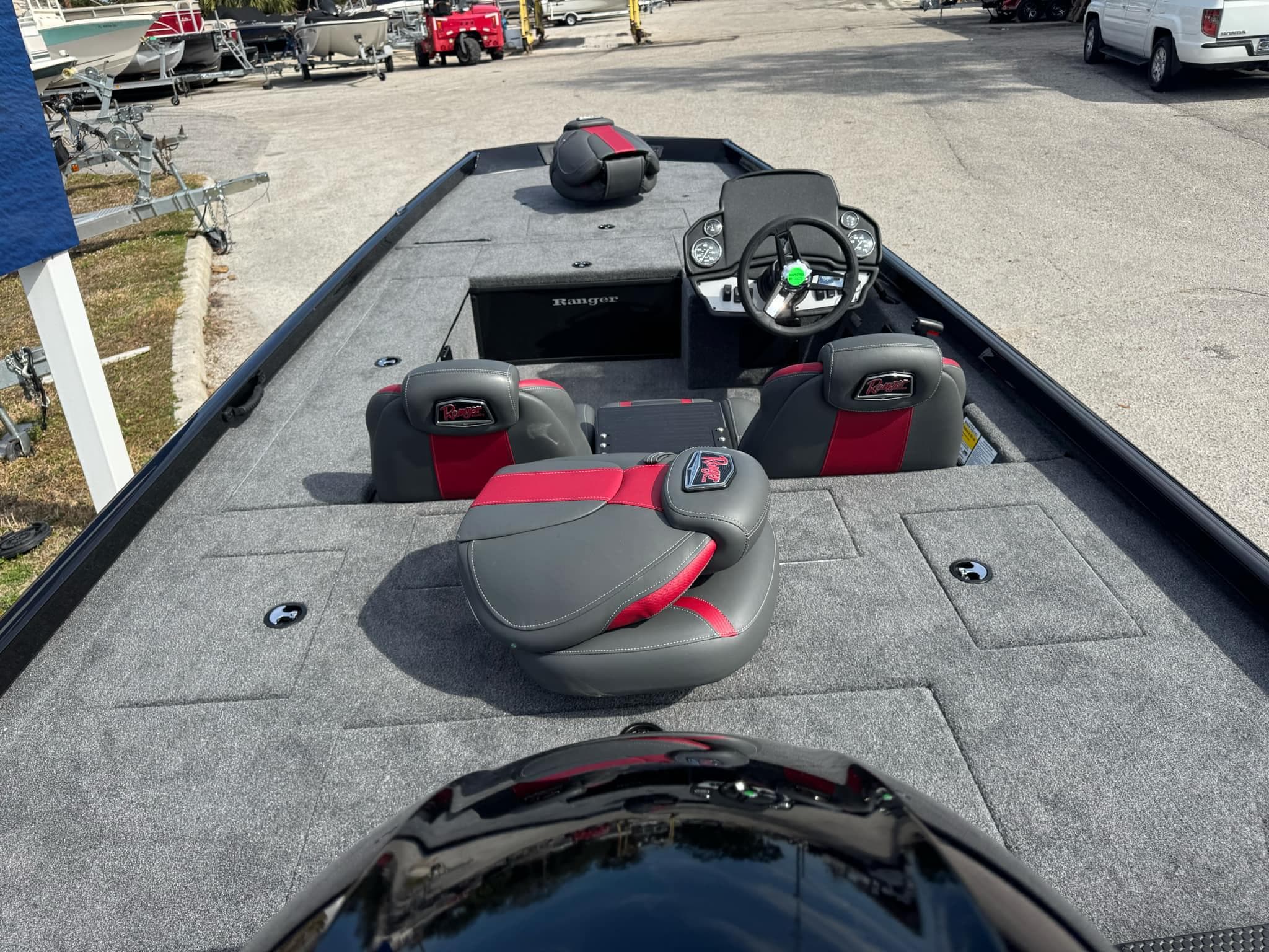 2025 Ranger RT188C boat interior with gray and red seating, steering console, and spacious deck.