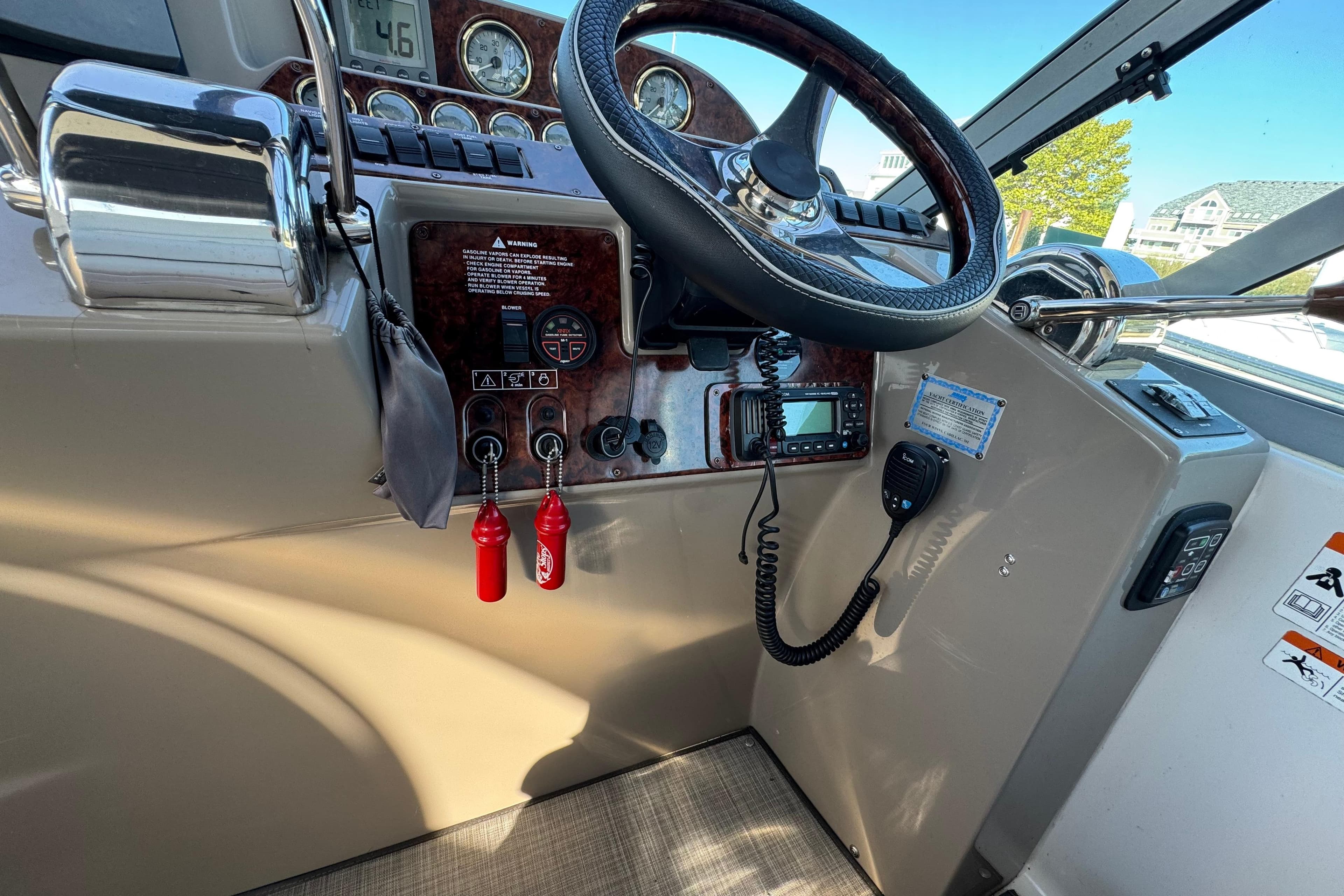 2004 Four Winns 378 Vista boat dashboard with steering wheel and control panel.