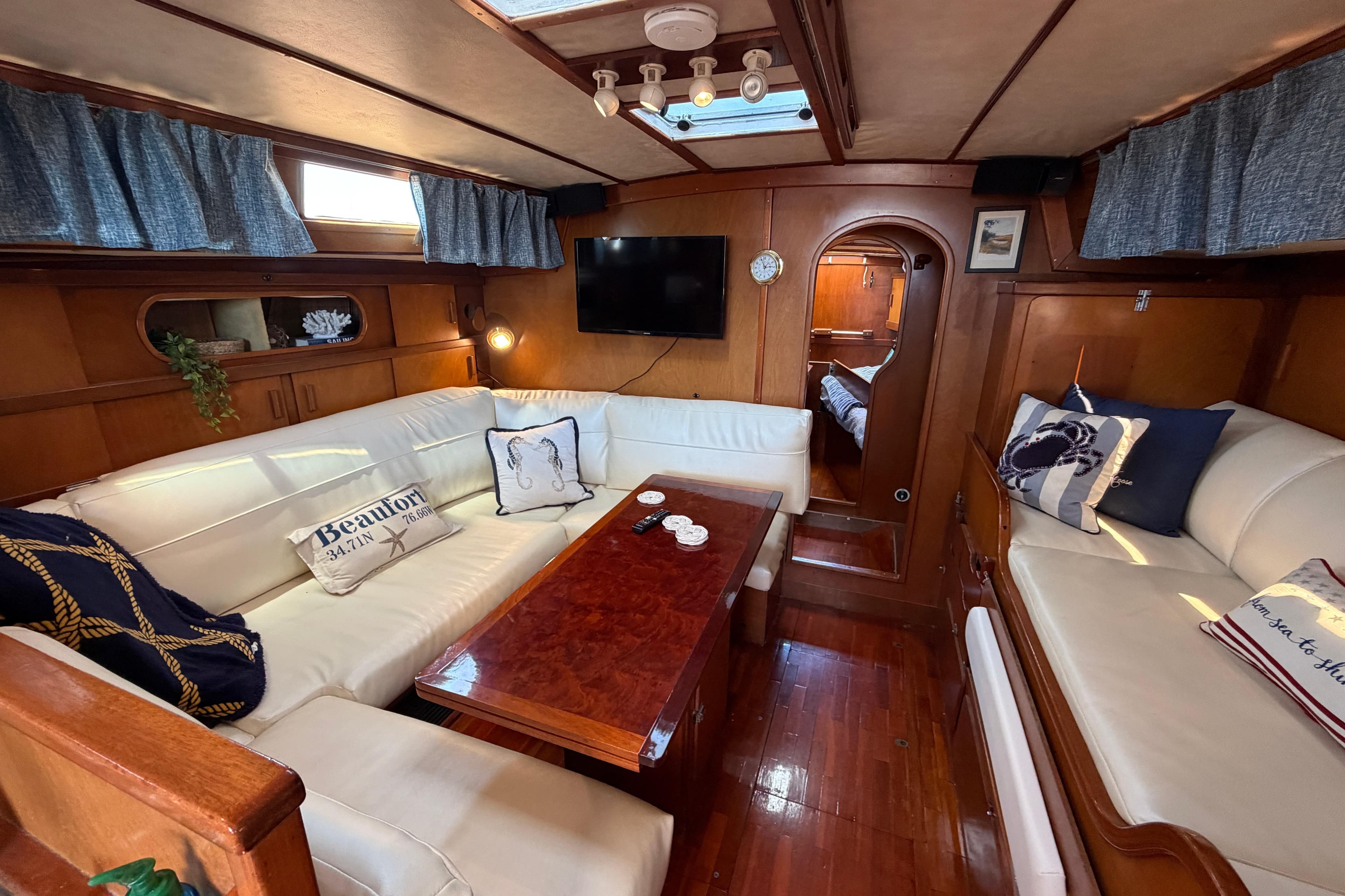 Luxurious interior of 1980 Amel Mango 52 yacht with cozy seating and elegant decor.