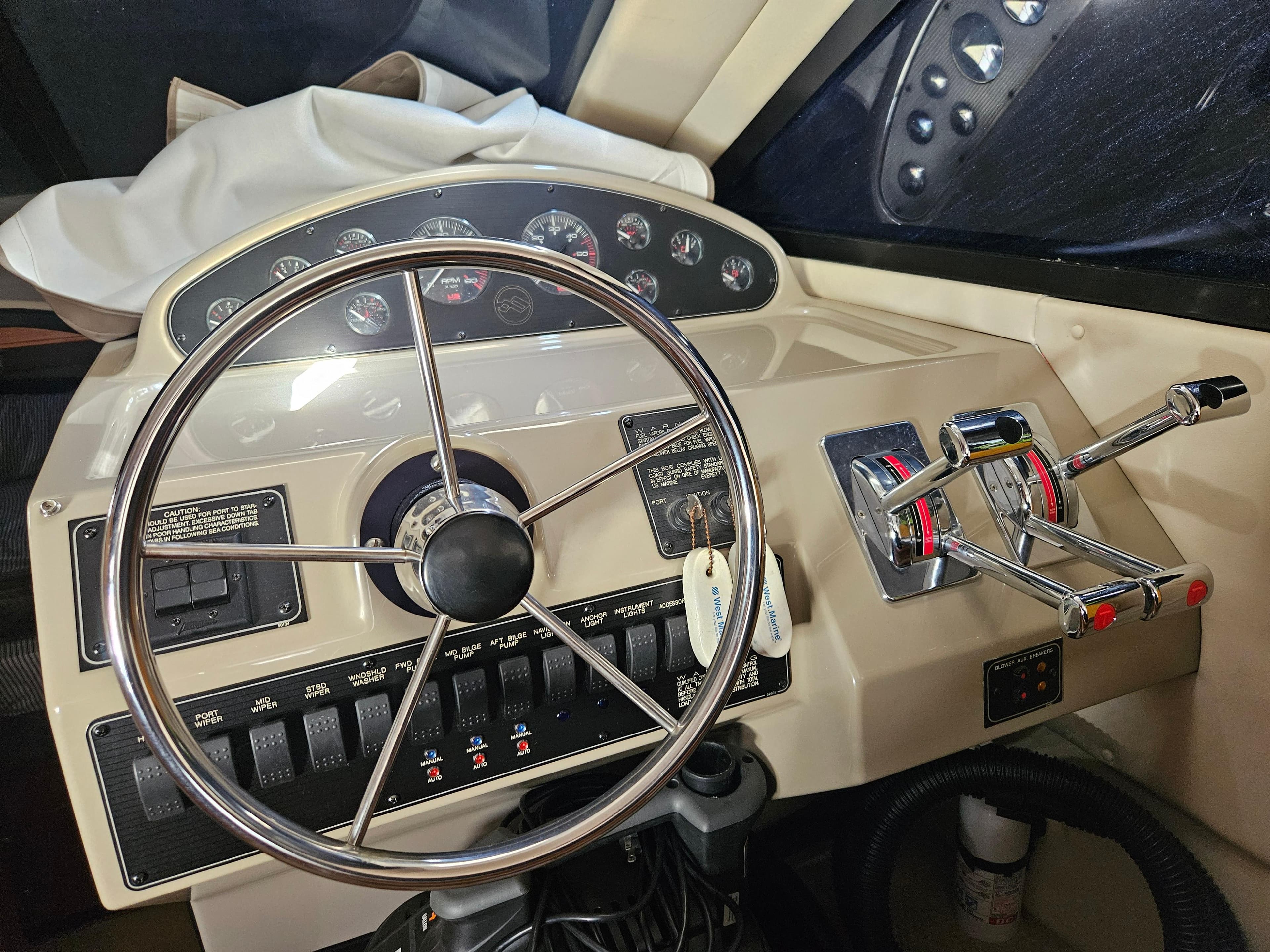 1997 Bayliner 3788 Command Bridge Motoryacht helm with steering wheel and control panel.