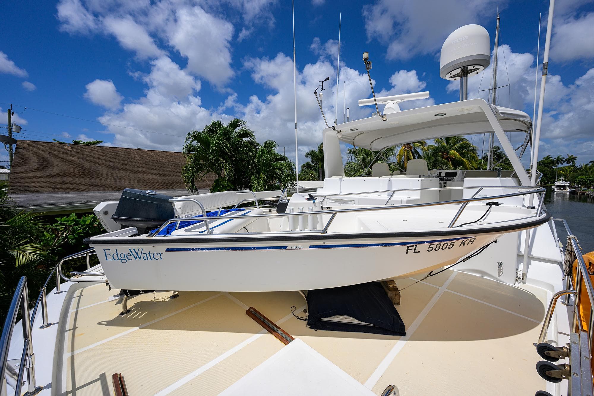 Ocean Alexander 602 yacht with EdgeWater boat on deck, 2001 model, under a clear blue sky.