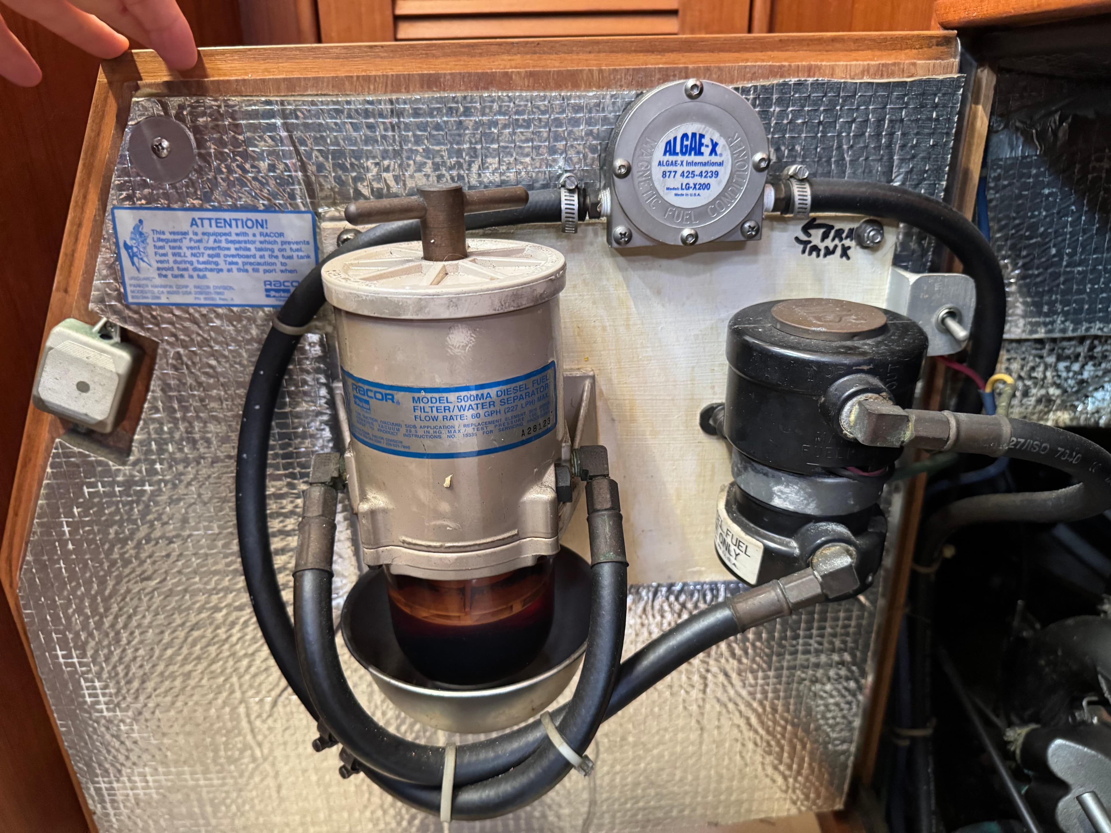 Fuel filtration system in a 1999 Island Packet 45 sailboat engine compartment.