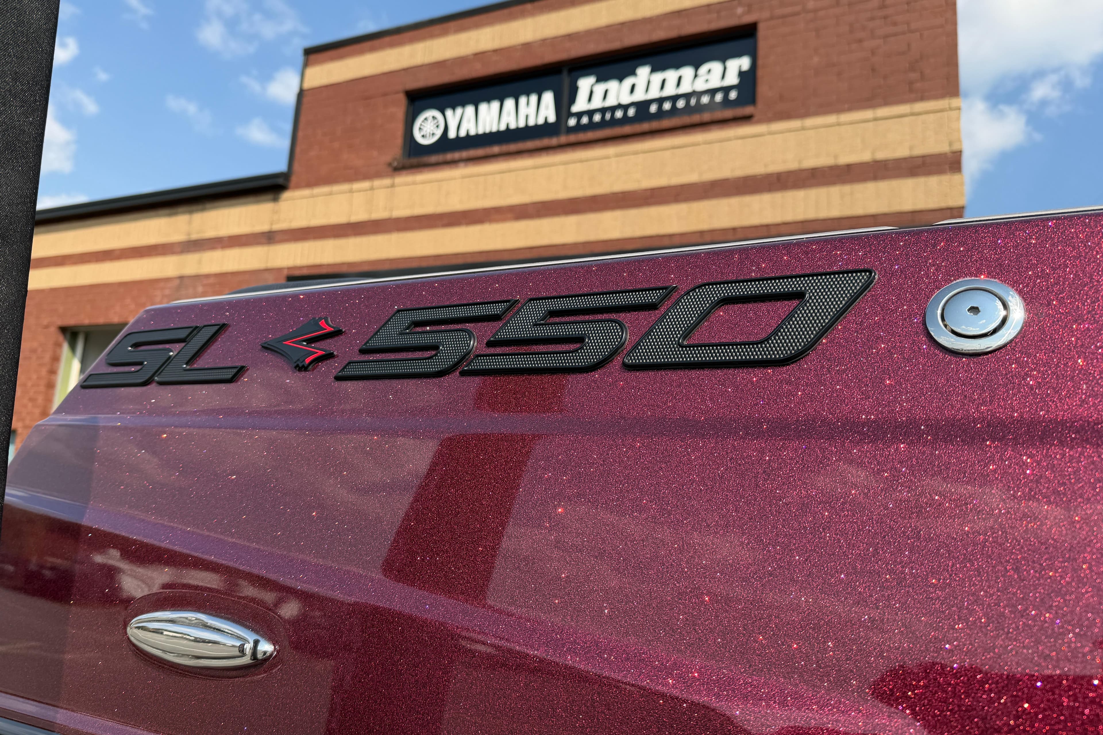 2023 Supra SL 550 boat with Yamaha Indmar building in background.