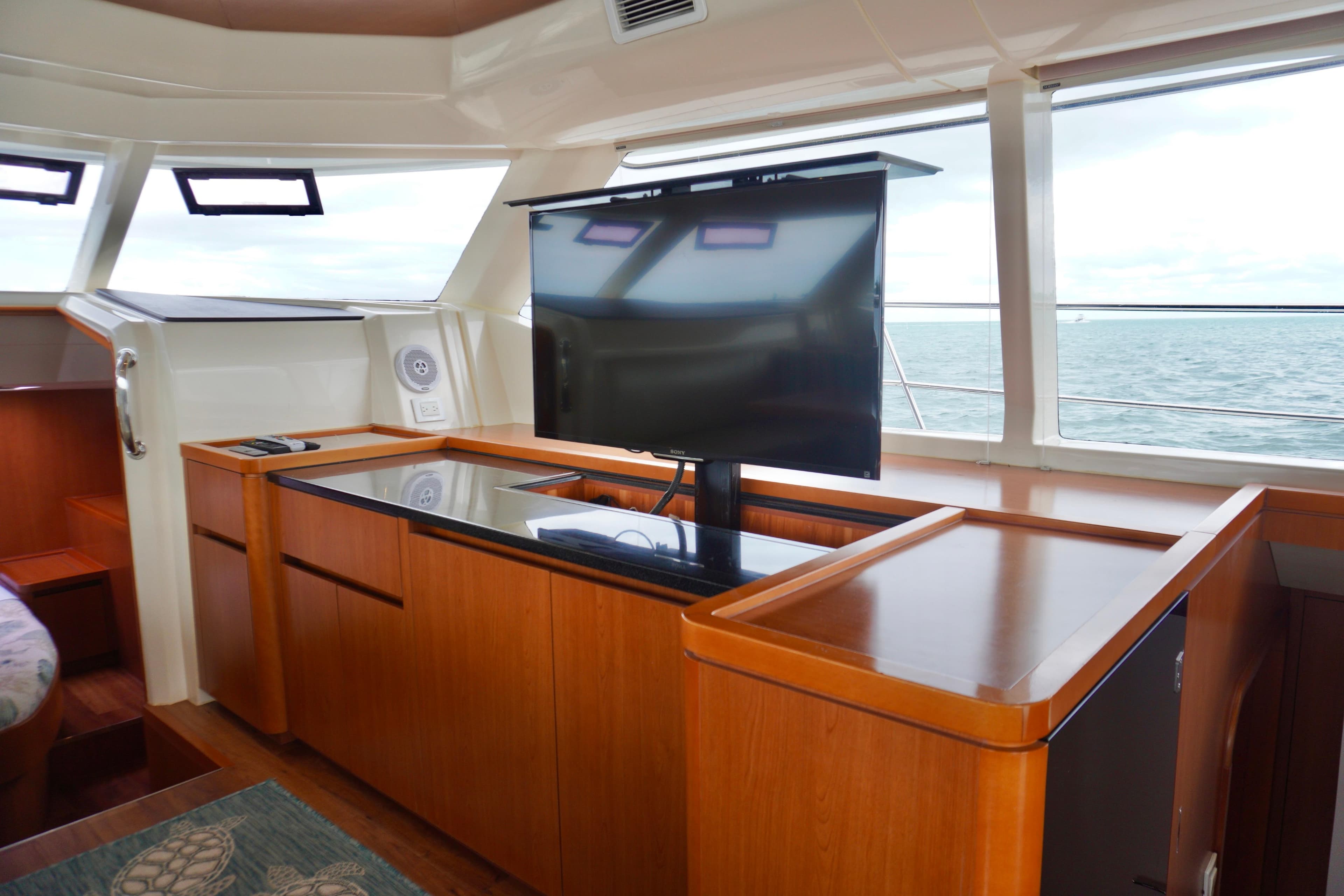 Luxurious interior of 2017 Aquila 44 Yacht with TV and ocean view.