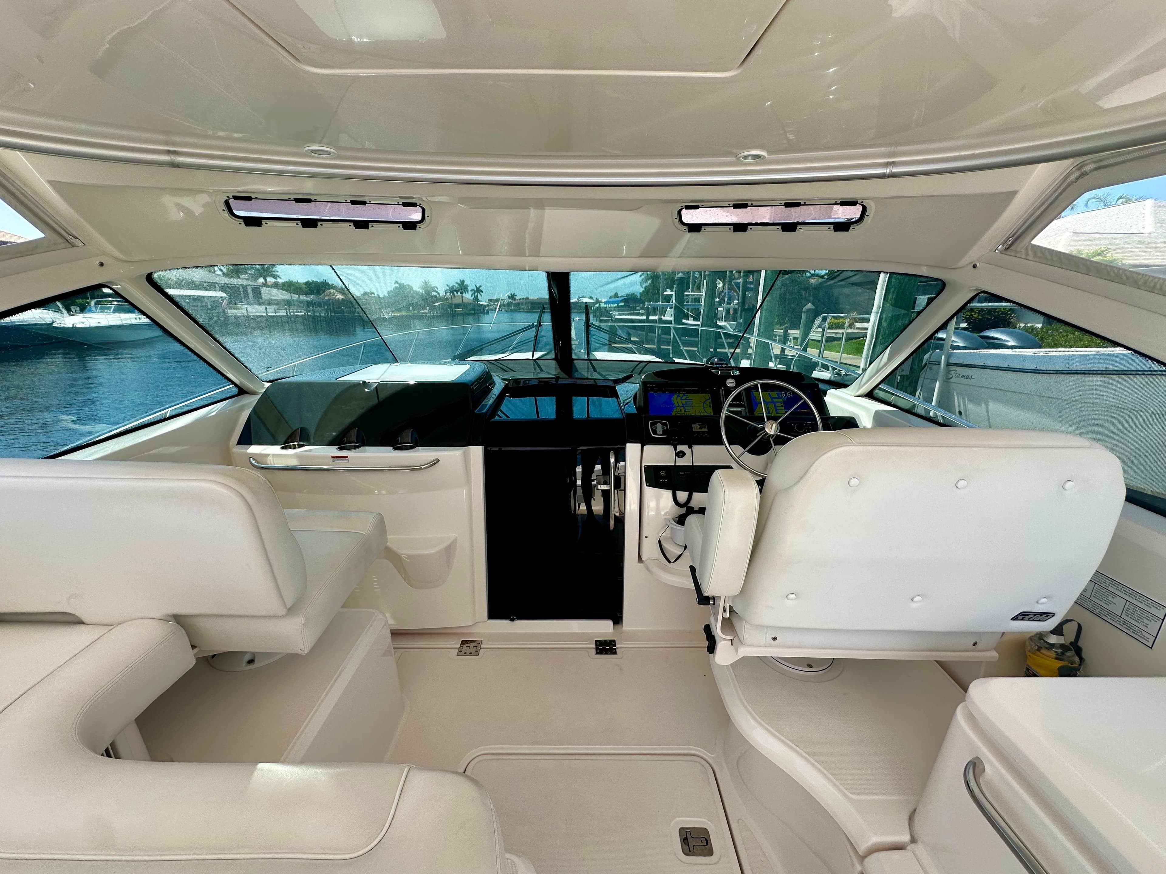 2018 Tiara Yachts 4300 Open helm with white seating and modern controls.
