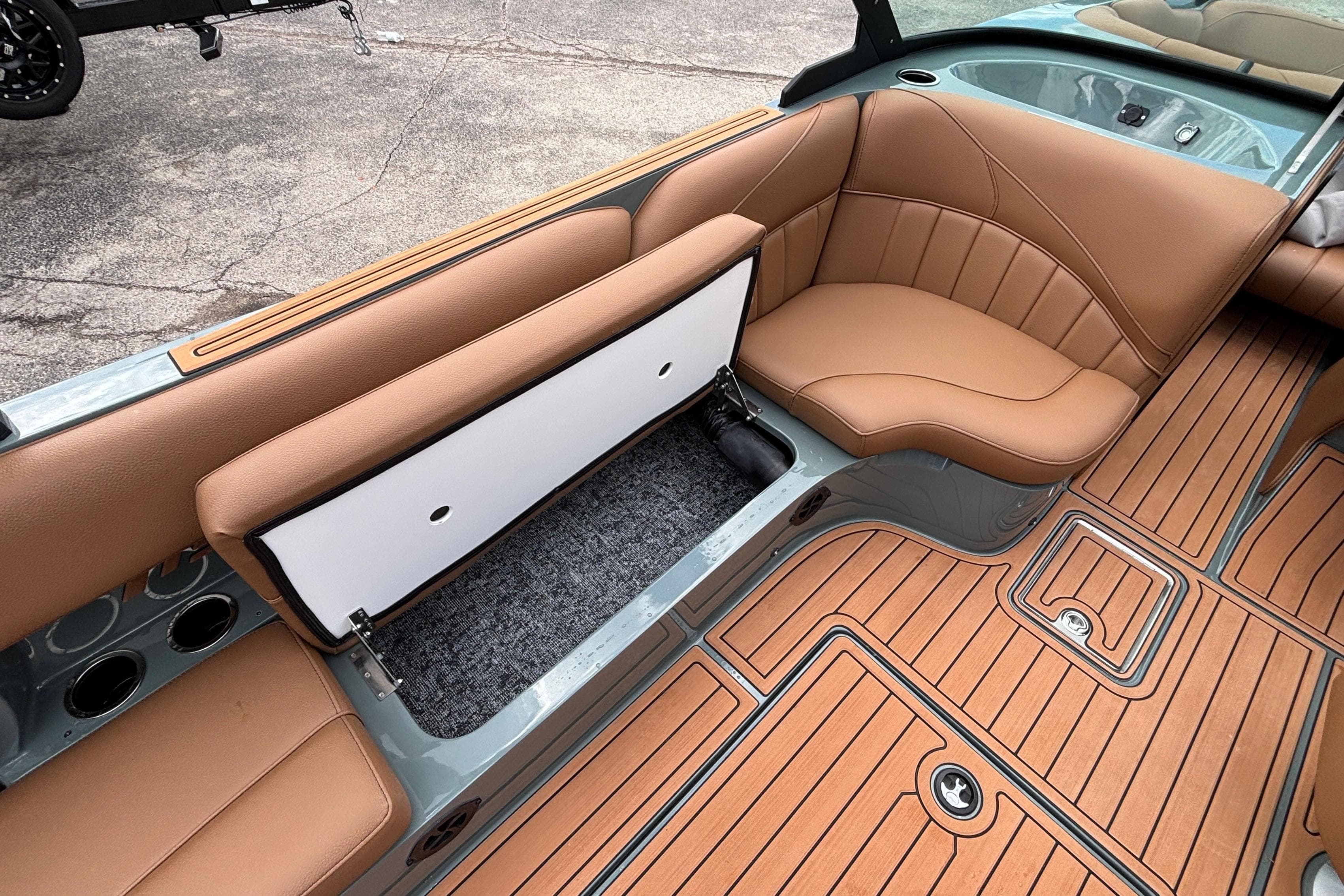 2026 MB B52 23 Classic boat interior with tan seating and storage compartment.