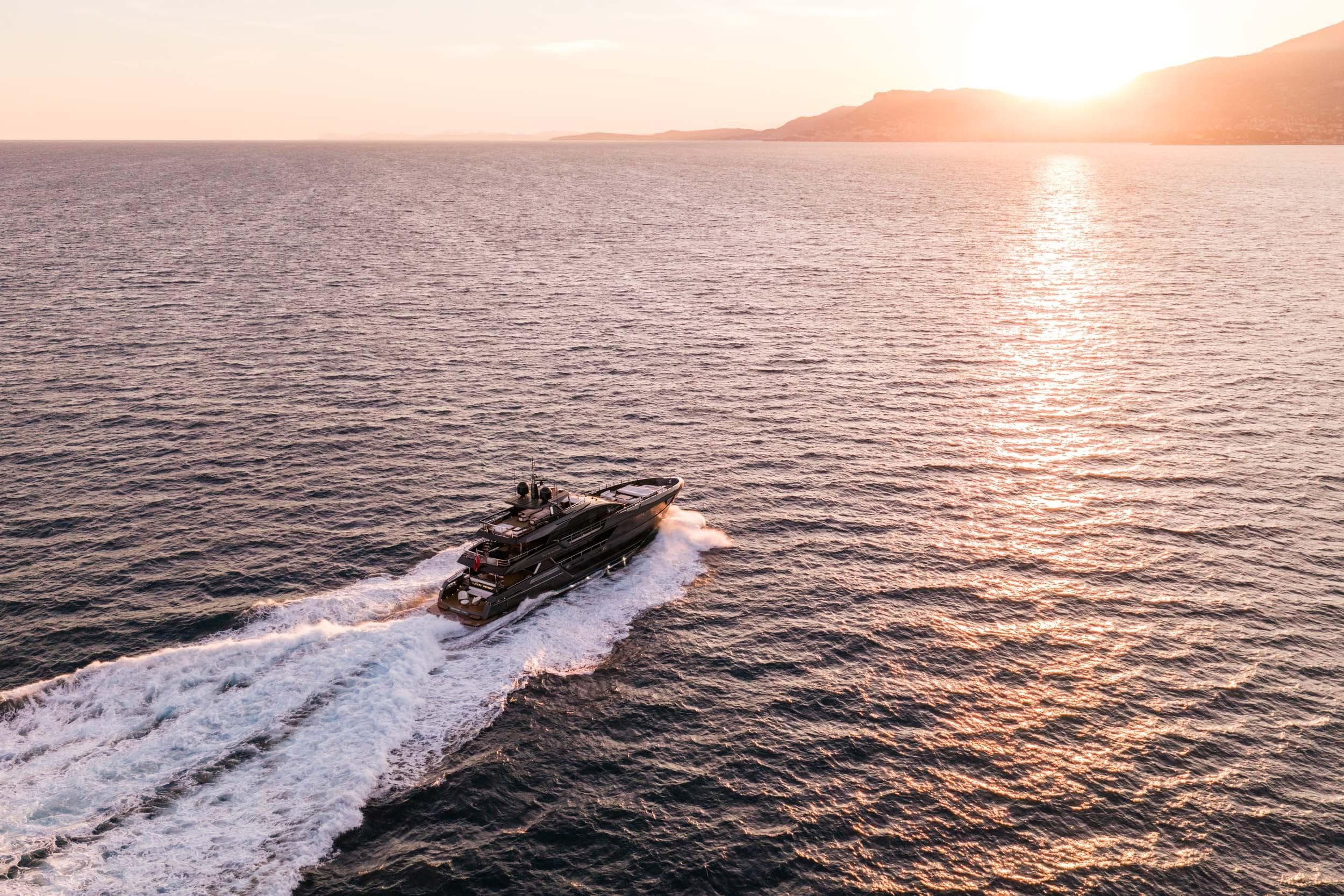 Luxury Riva 130' Bellissima yacht cruising at sunset, 2023 model.