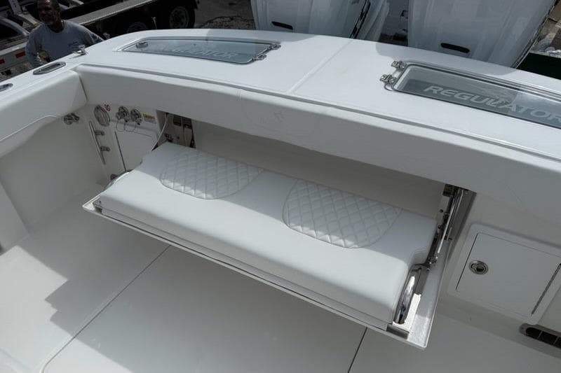 2026 Regulator 31 boat with fold-out seating and storage compartment.