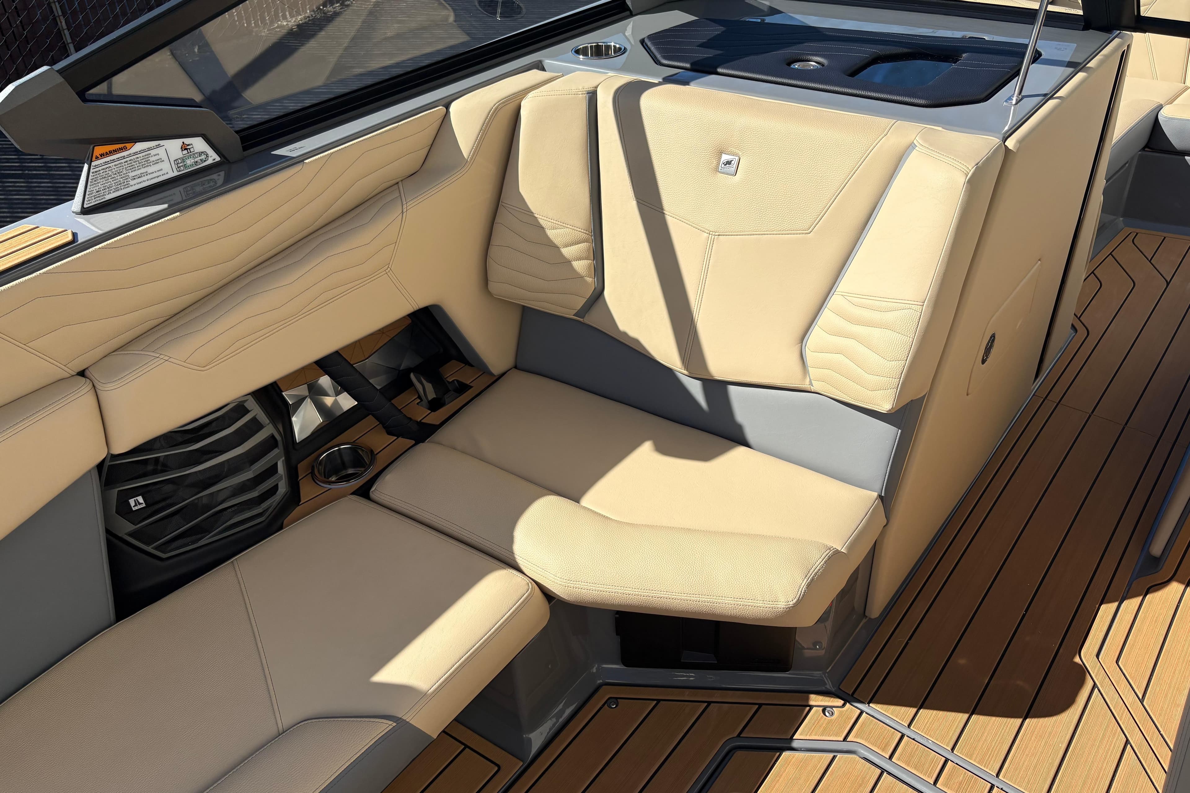 2026 Nautique Super Air Nautique G23 interior with beige seating and teak flooring.