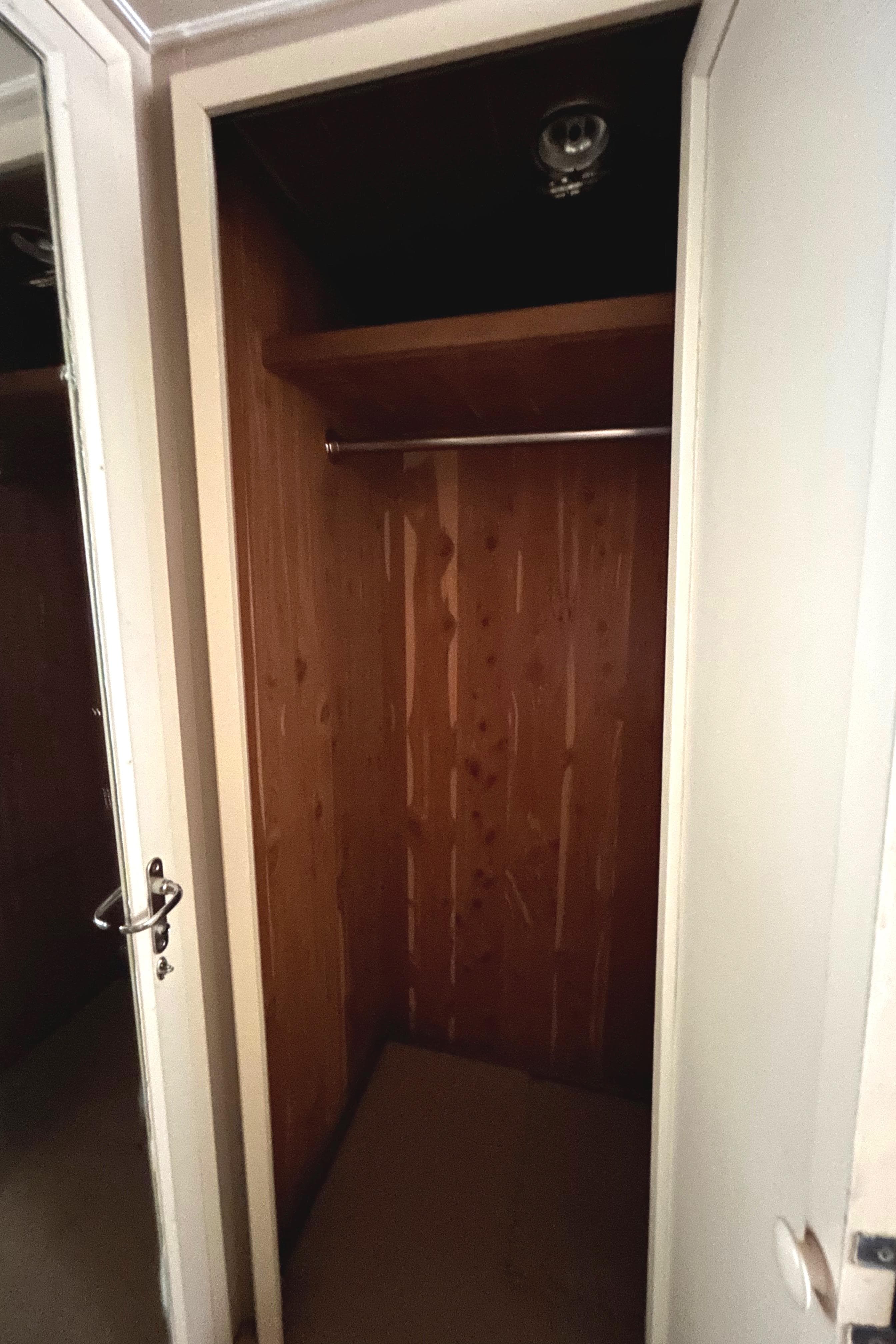 Empty wooden closet inside a 1991 Hatteras Cockpit Motor Yacht.
