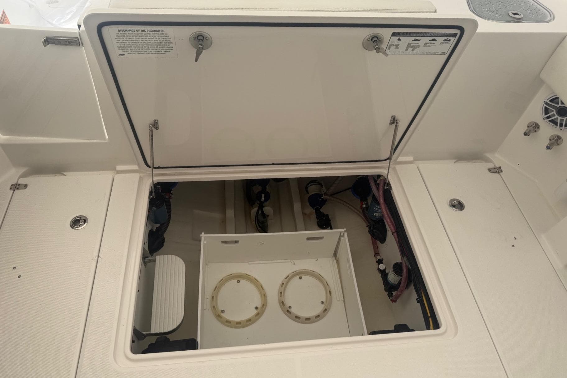 2023 Edgewater 340CC boat storage compartment with open hatch, showcasing internal components.