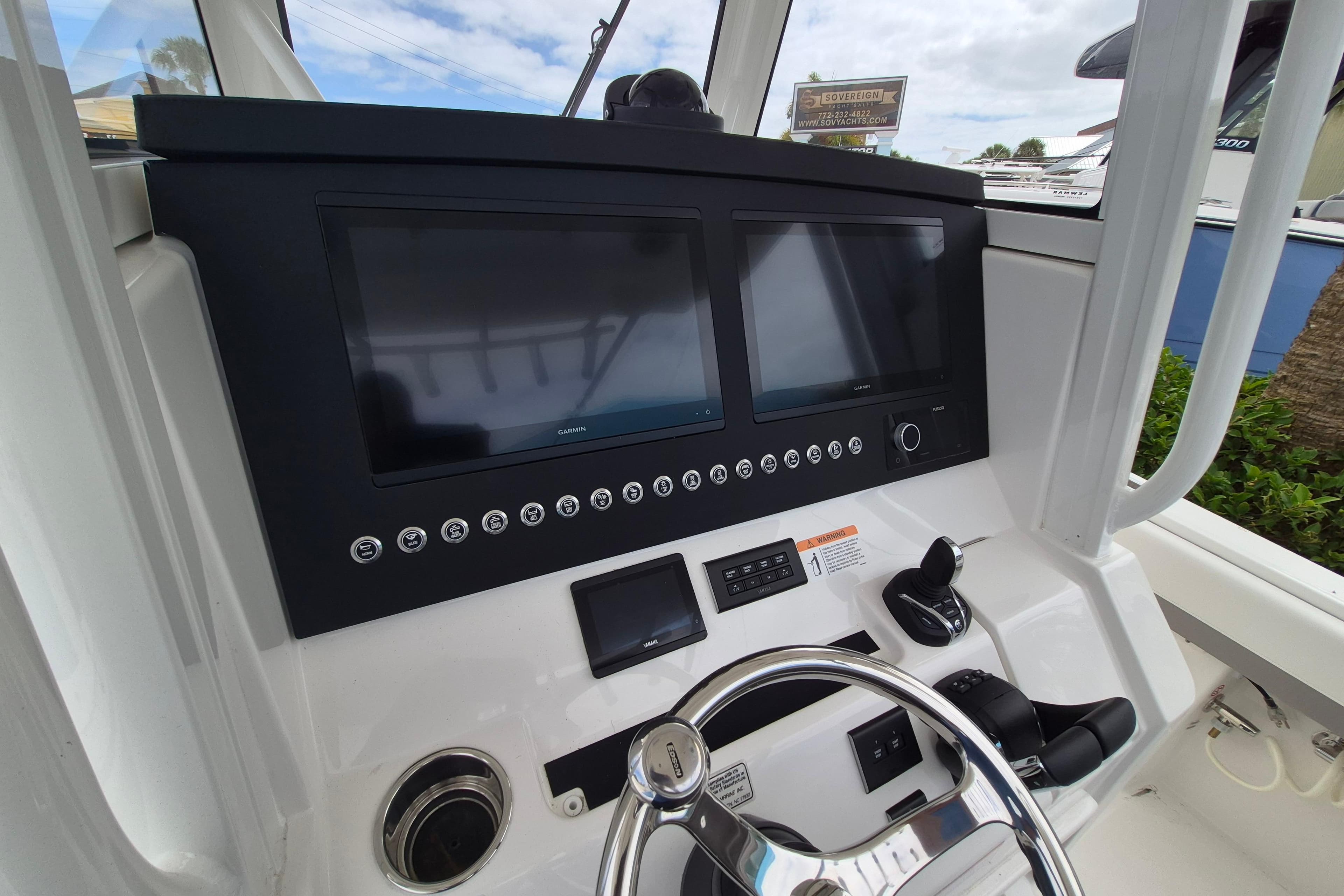 2026 Regulator 31 boat dashboard with dual Garmin displays and steering wheel.