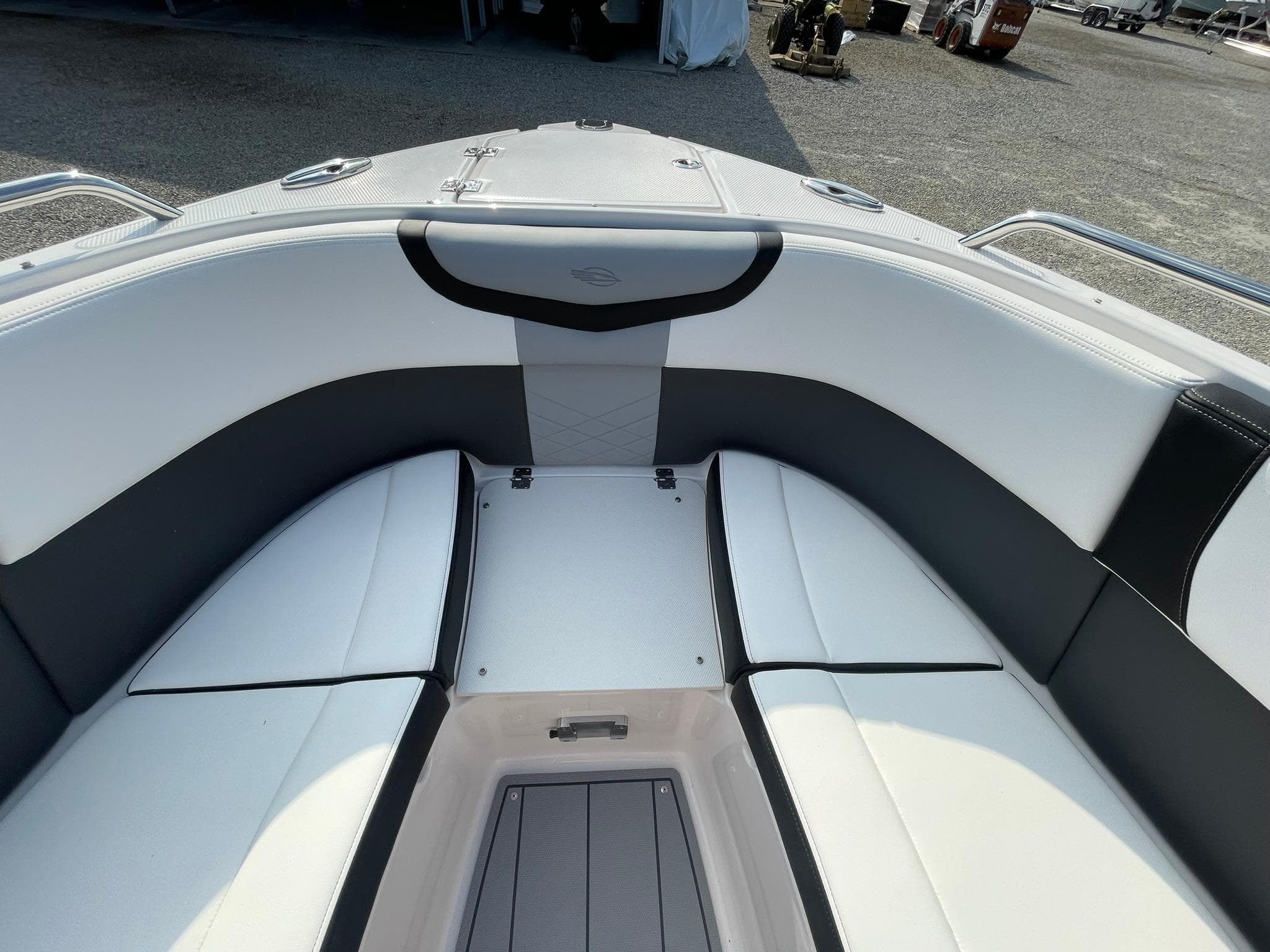 2025 Chaparral 270 OSX boat interior with sleek white and black seating.
