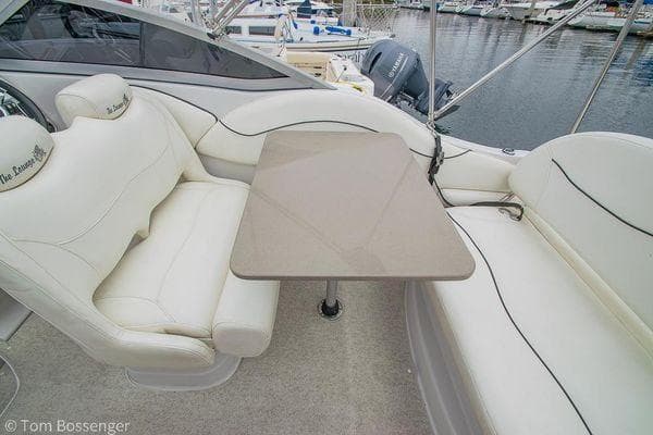 2004 Crownline 250 CR boat interior with white seating and table, docked at marina.