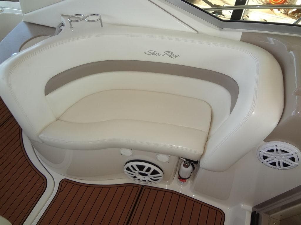 2005 Sea Ray 320 Sundancer boat interior with white seating and wood flooring.