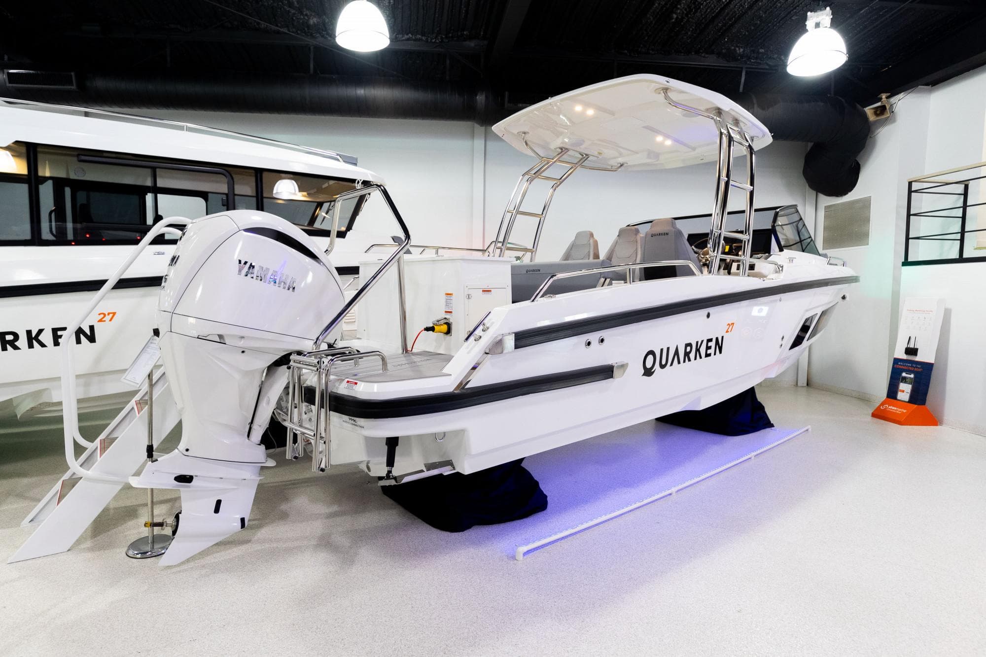 2024 Quarken 27 T-Top V2 boat with Yamaha engine in showroom.