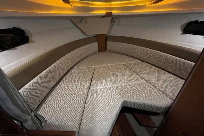 2020 Ranger Tugs R-27 cabin interior with patterned cushions and ambient lighting.