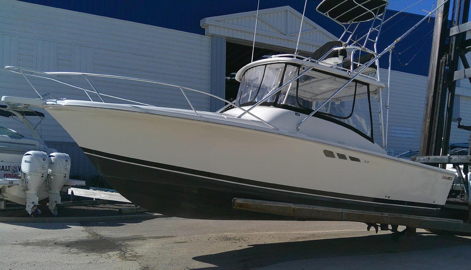 Luhrs Tournament 290 Open 2000 boat in dry dock, side view.