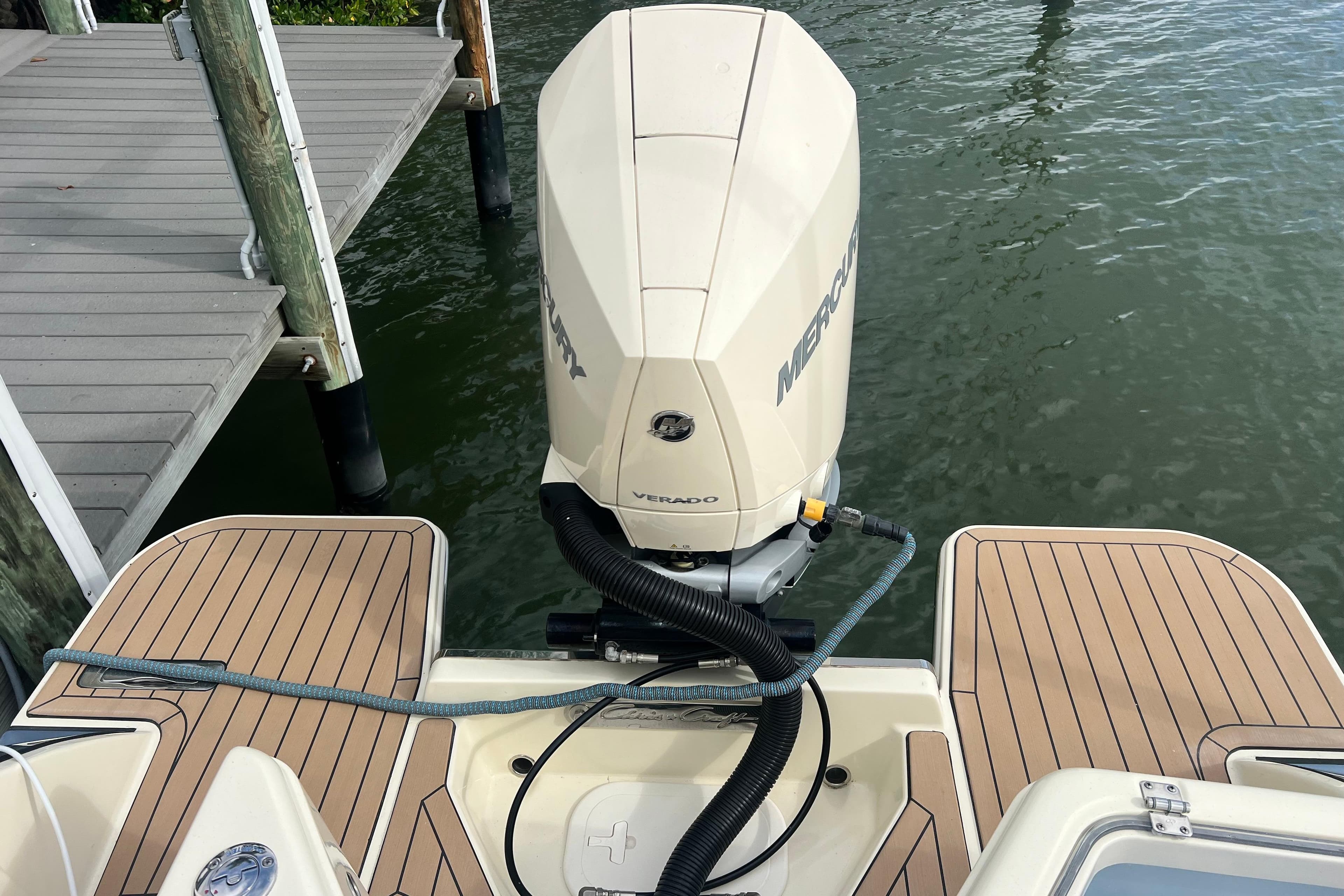 2024 Chris-Craft Calypso 24 with Mercury Verado engine, docked on water.