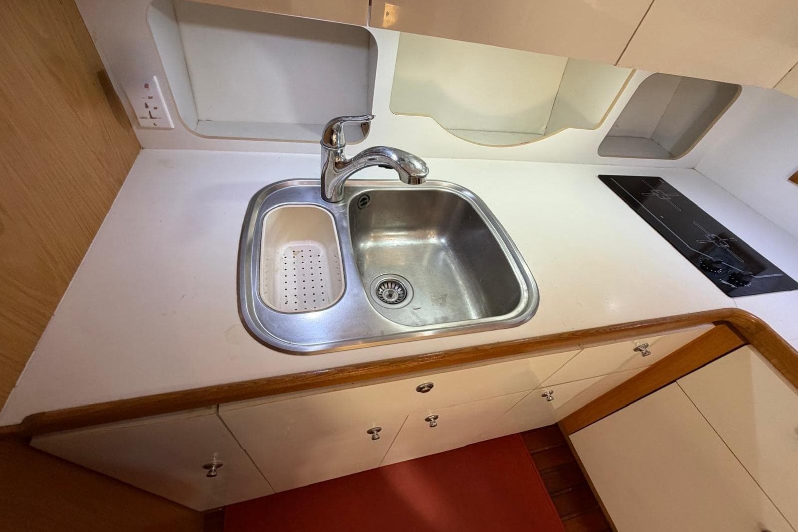 1999 Tiara Yachts 4100 Open kitchen with stainless steel sink and electric stove.