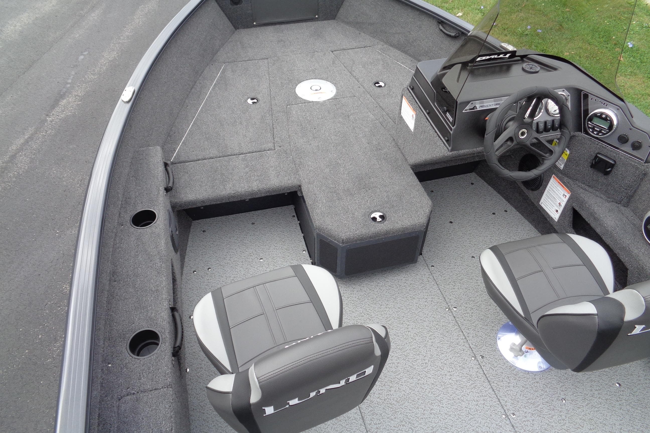 2026 Lund 1675 Adventure SS boat interior with seating and steering console.