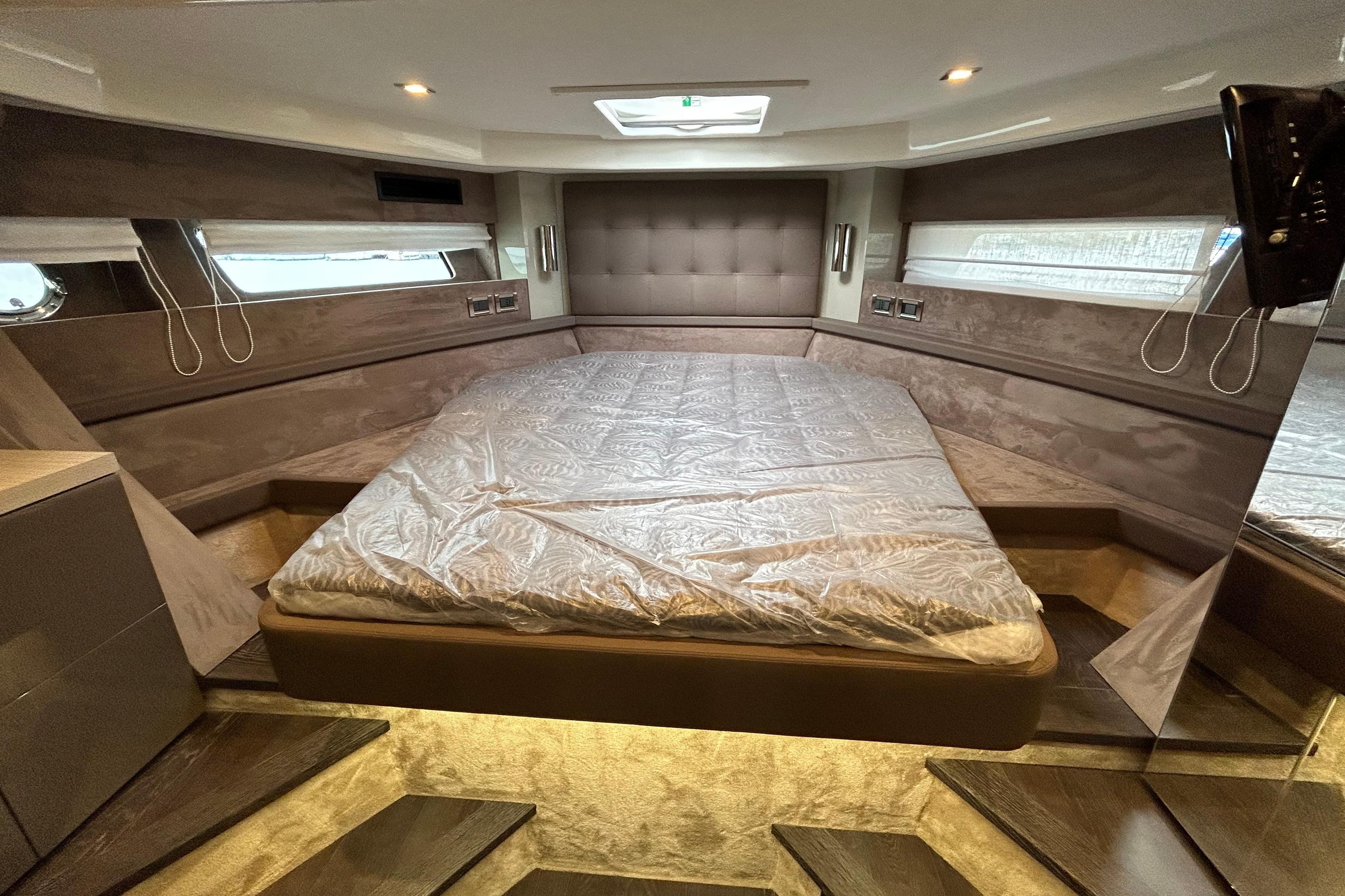 Luxurious interior of 2023 Cranchi 60 ST yacht with spacious bed and modern design.